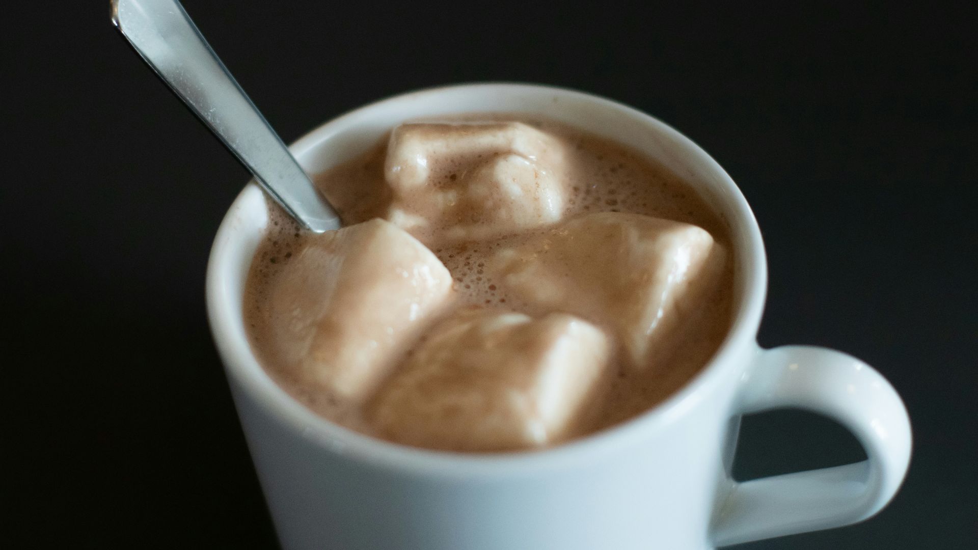 a cup of hot chocolate with marshmallows in it