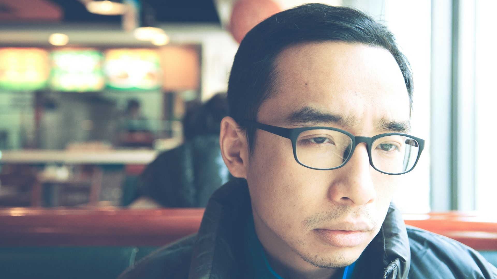 man in black framed eyeglasses and black jacket