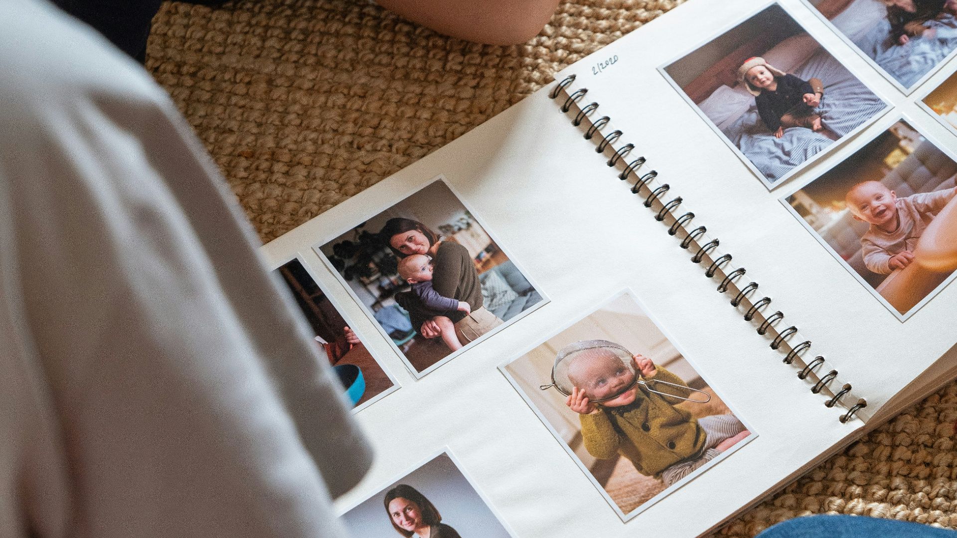 a young boy sitting on the floor reading a book