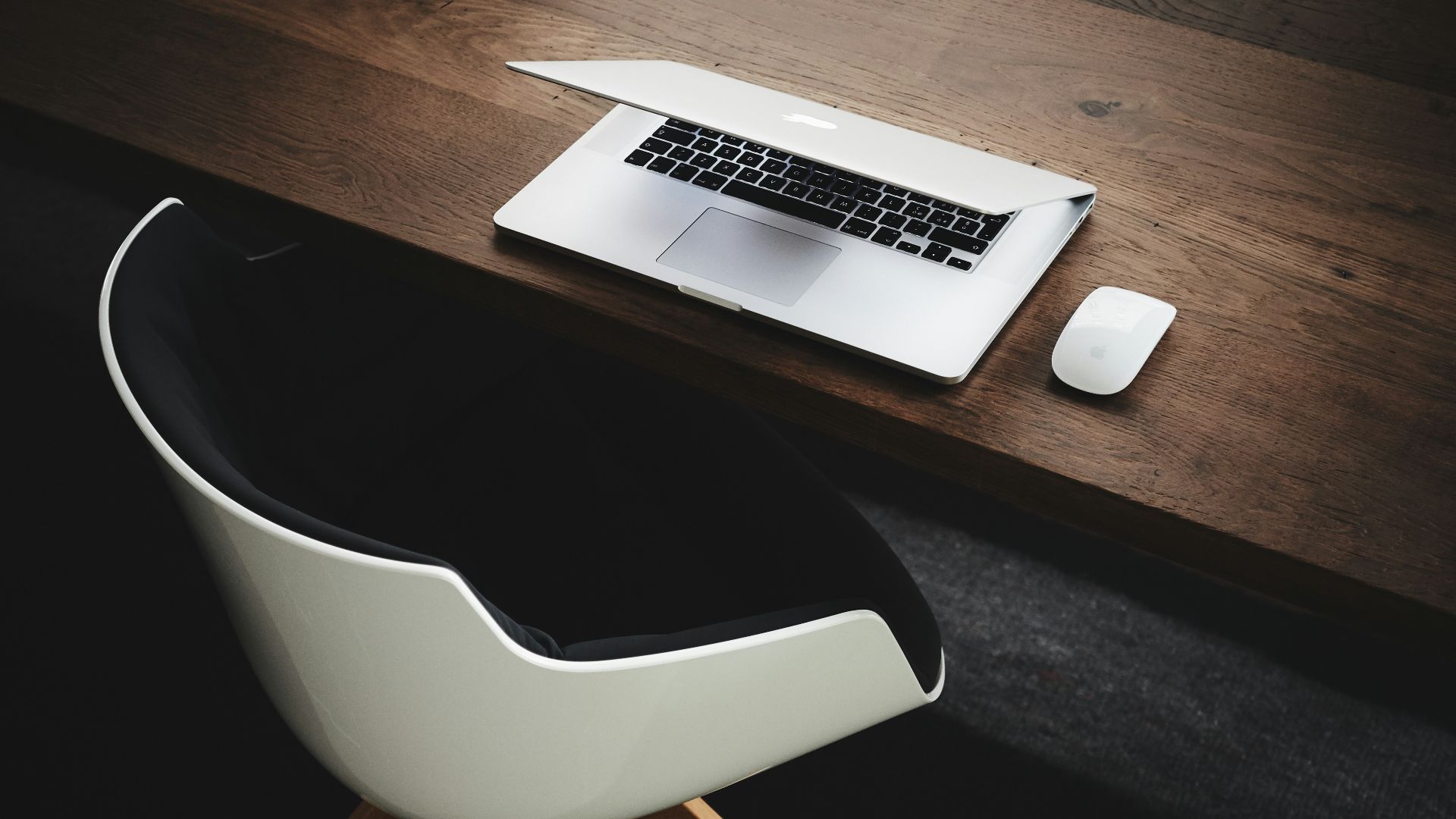 Apple MacBook beside computer mouse on table