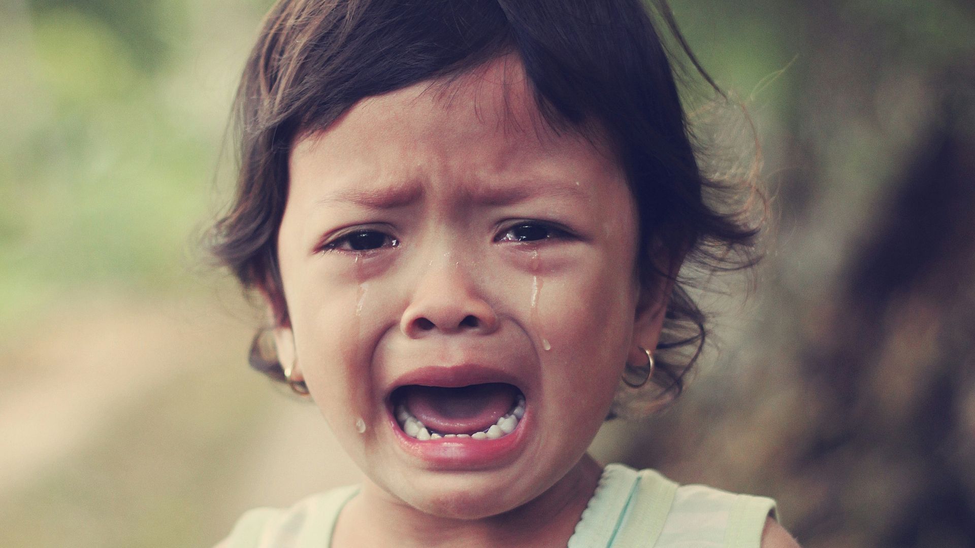 selective focus photography of girl crying