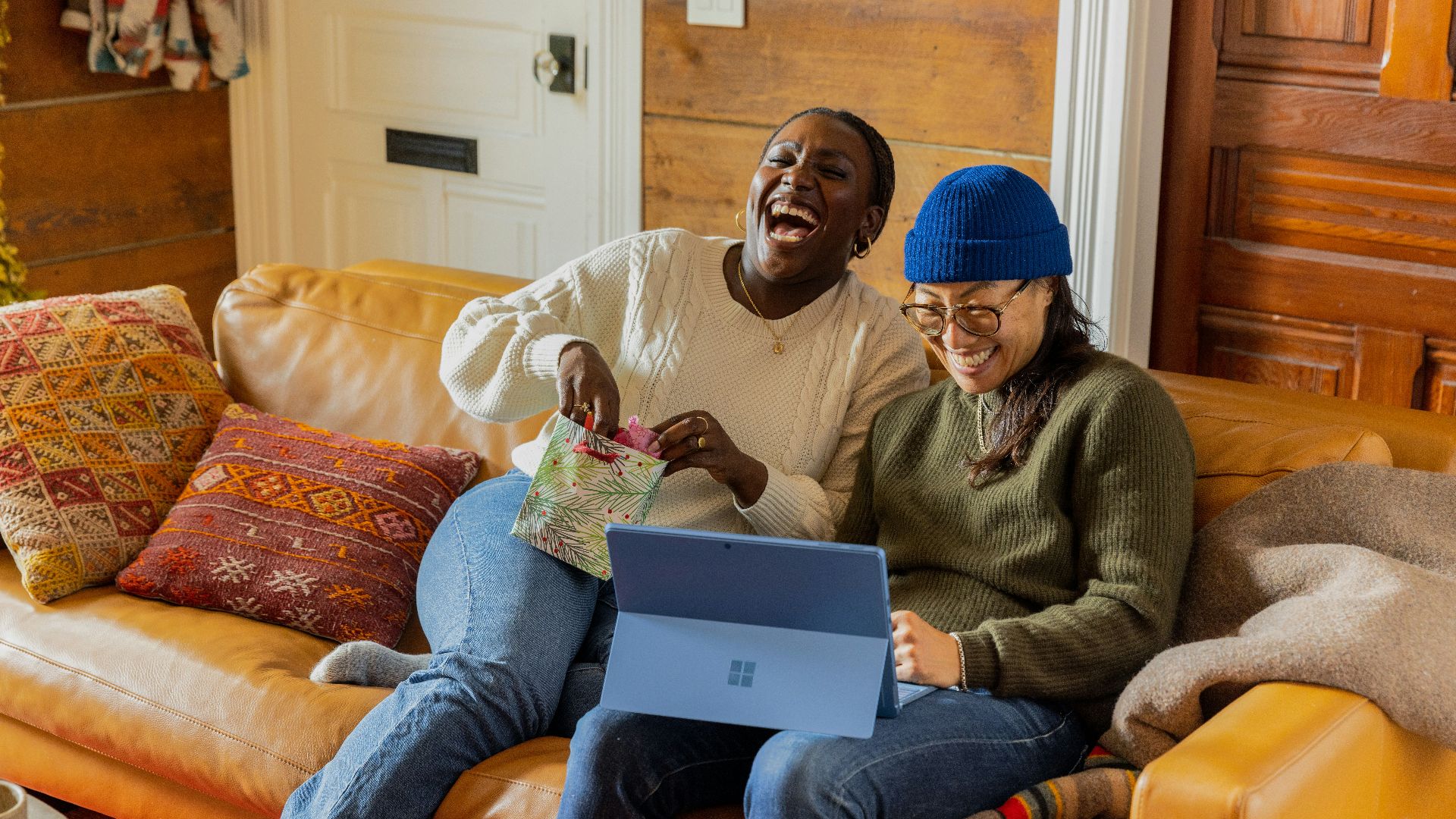 a person sitting on a couch with a laptop