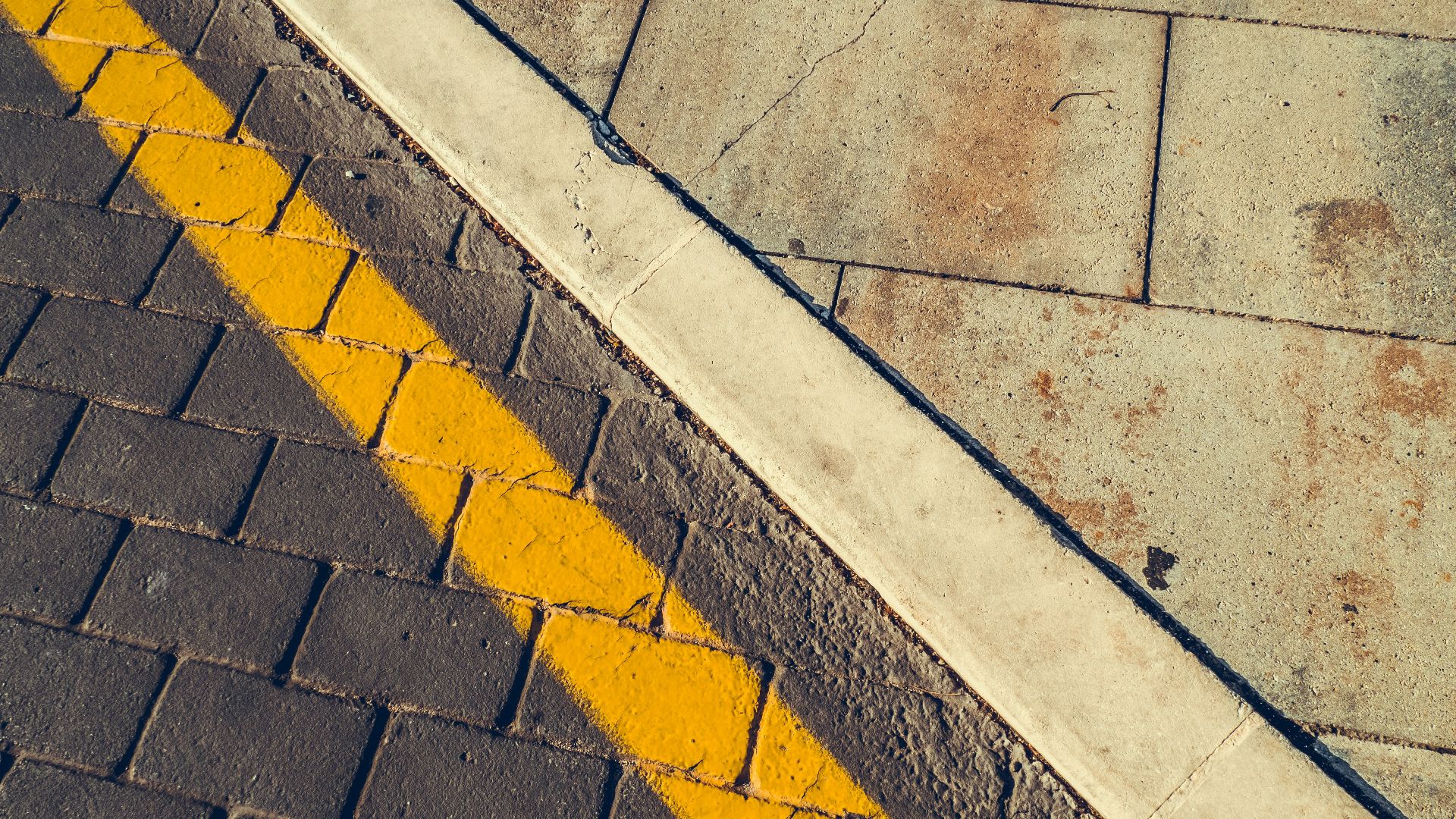 gray concrete pavement with yellow and white line