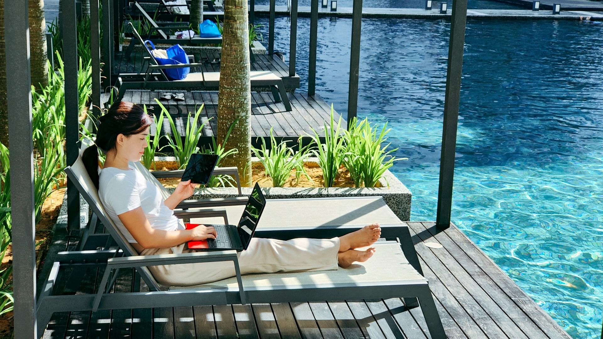 a person sitting on a bench with a laptop