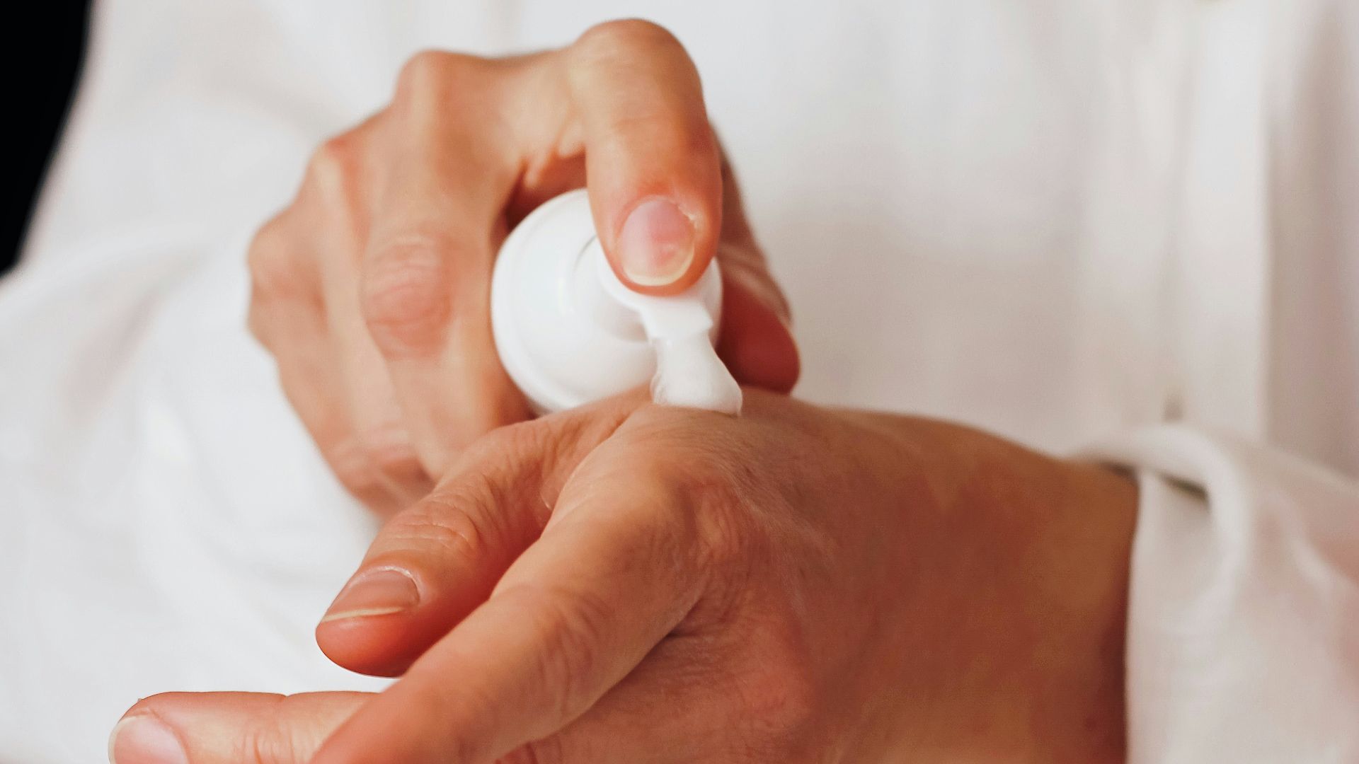 person holding white round ornament