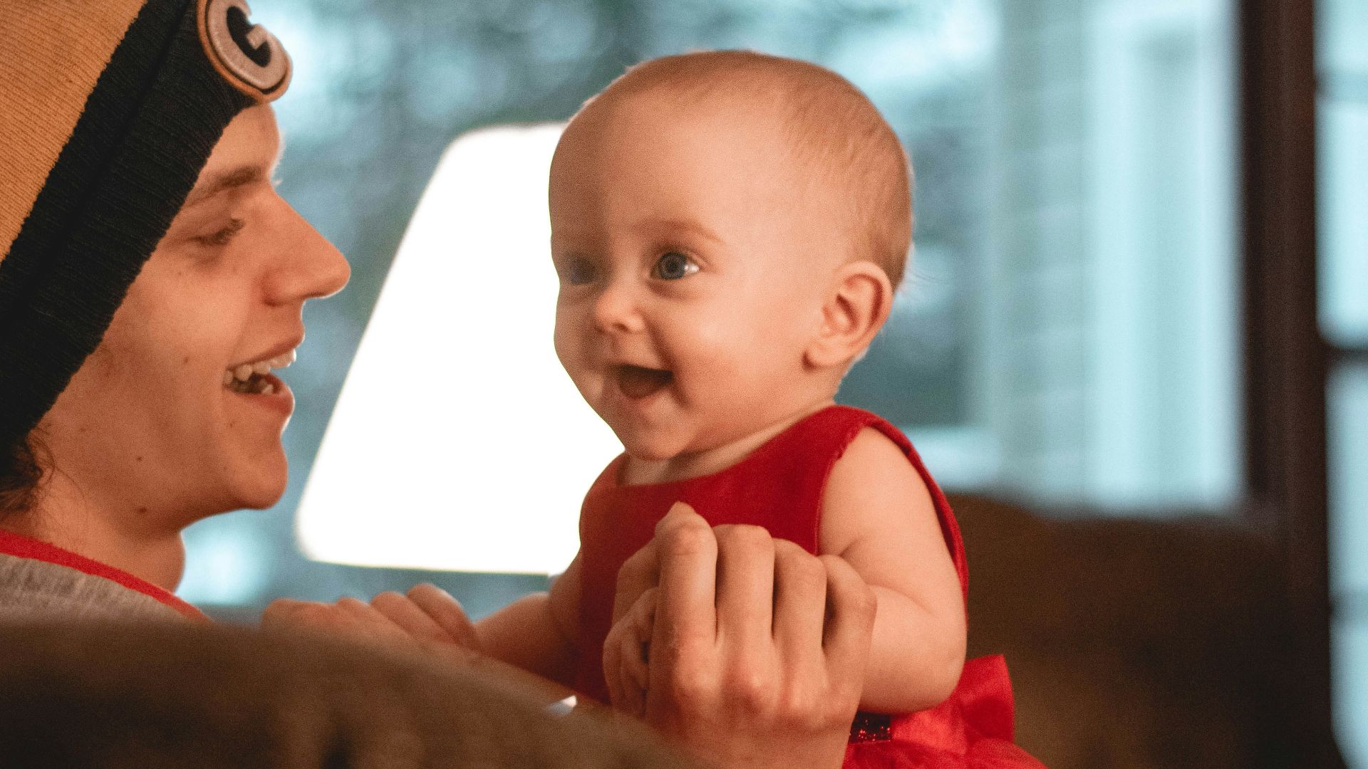 smiling woman holding a smiling child