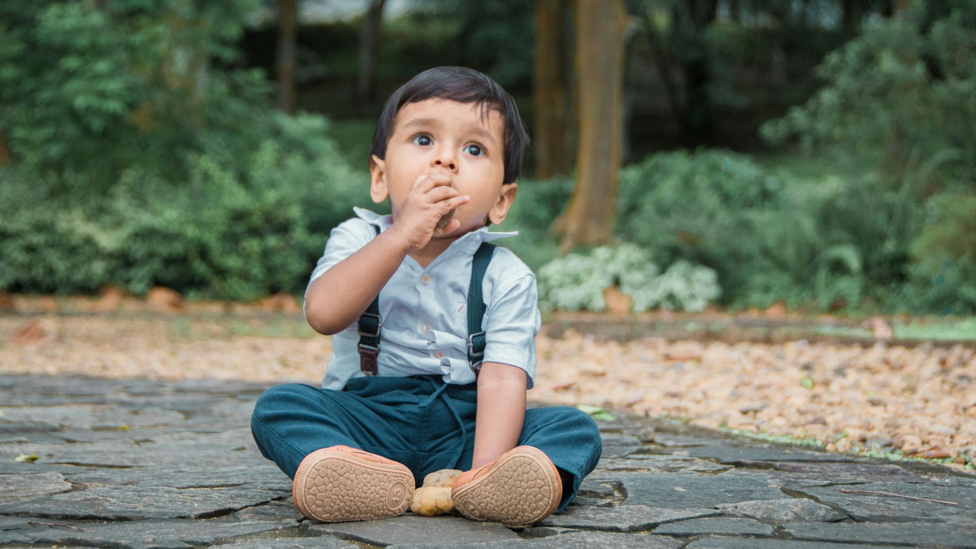 a child sitting on a rock