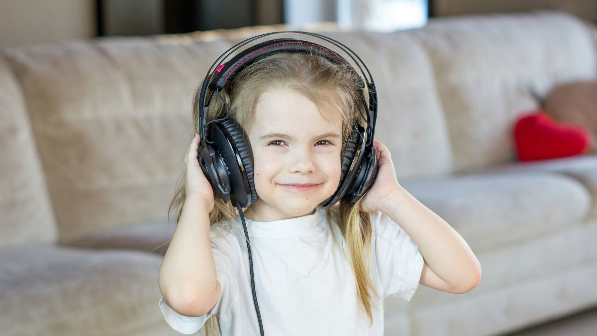 a little girl with headphones on her ears