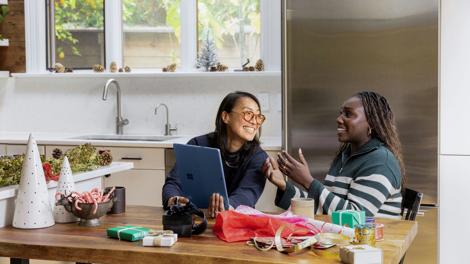 a woman sitting at a table in front of a window