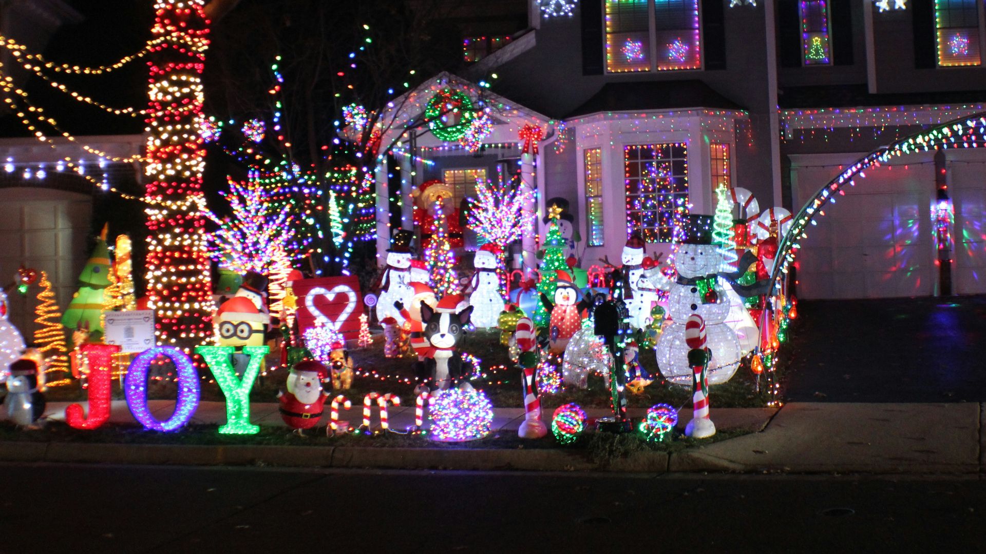 a house covered in christmas lights and decorations