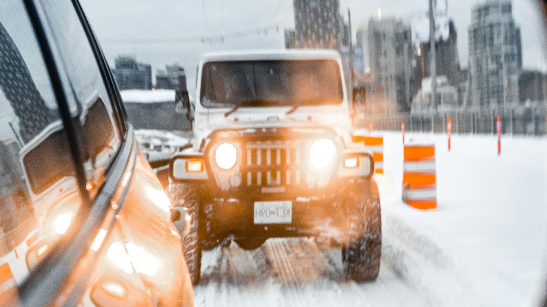 yellow car on road covered with snow during daytime