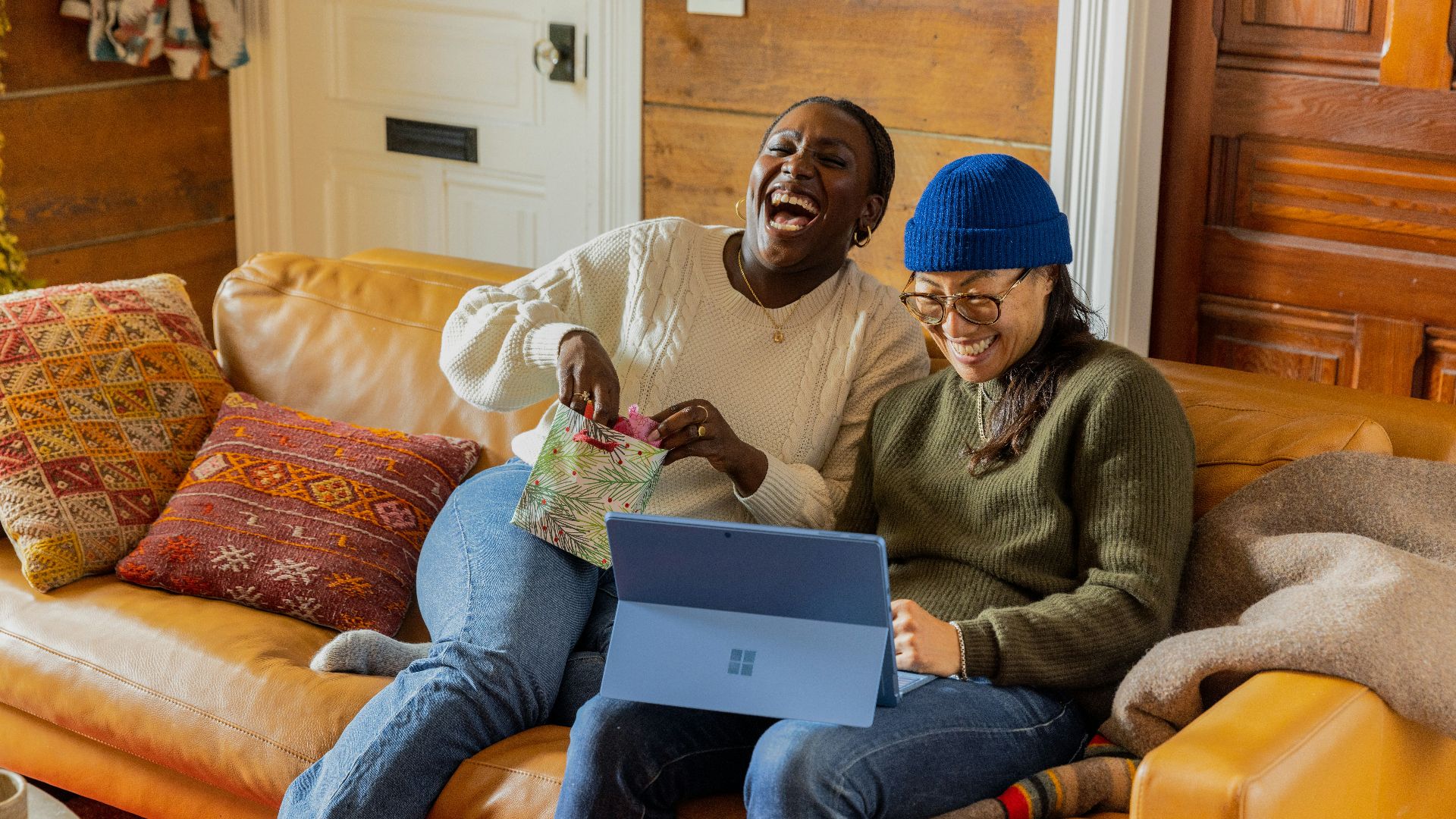 a person sitting on a couch with a laptop