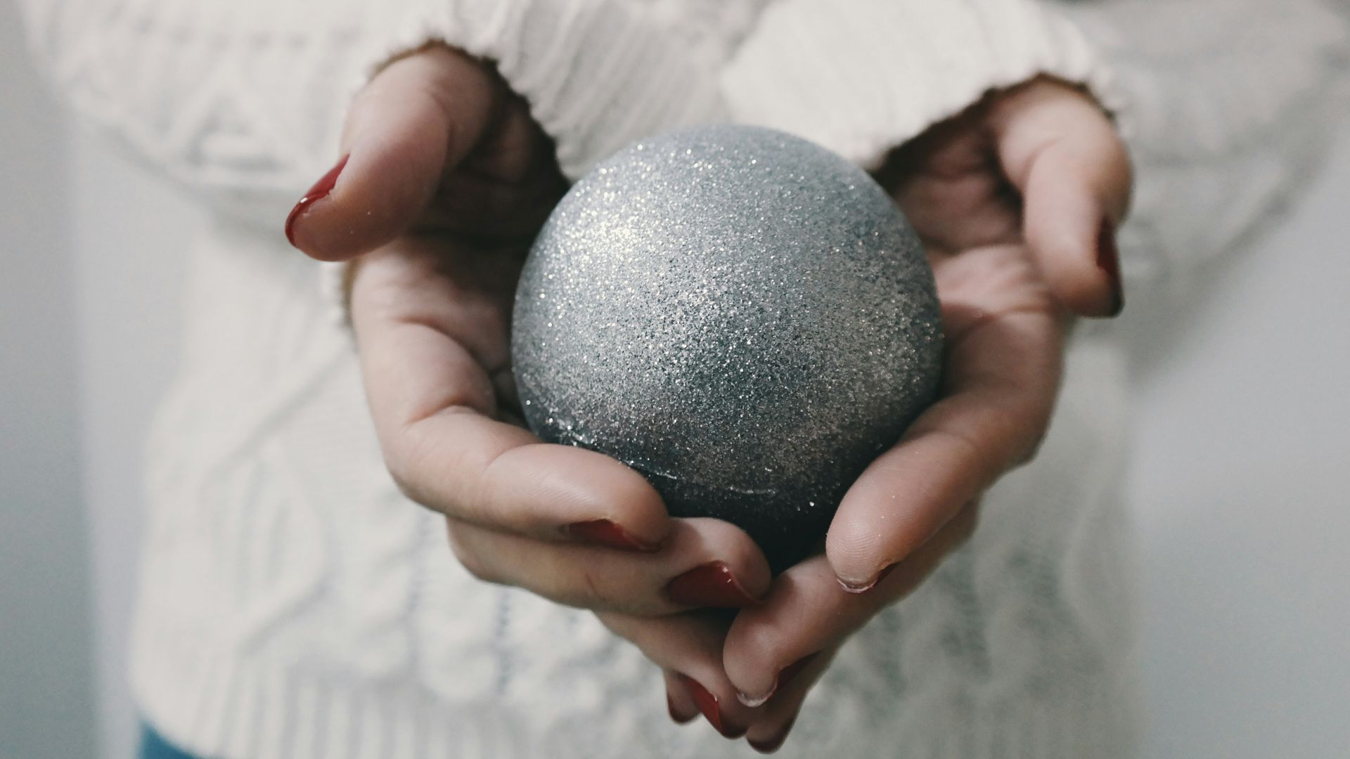 woman holding gray bath bomb