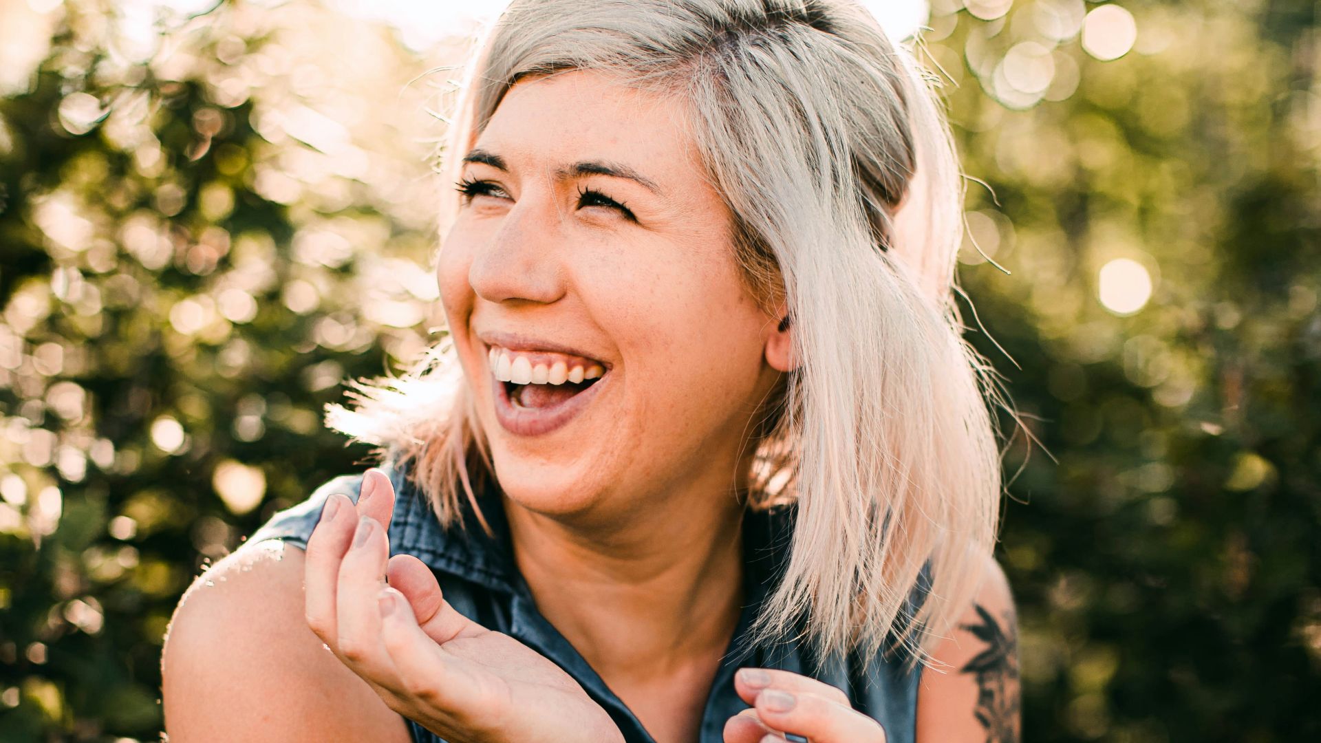 woman in black tank top smiling