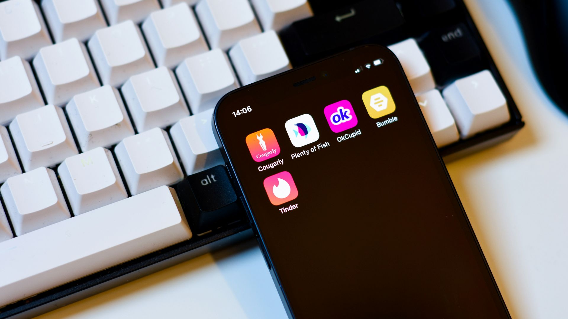 a cell phone sitting next to a keyboard