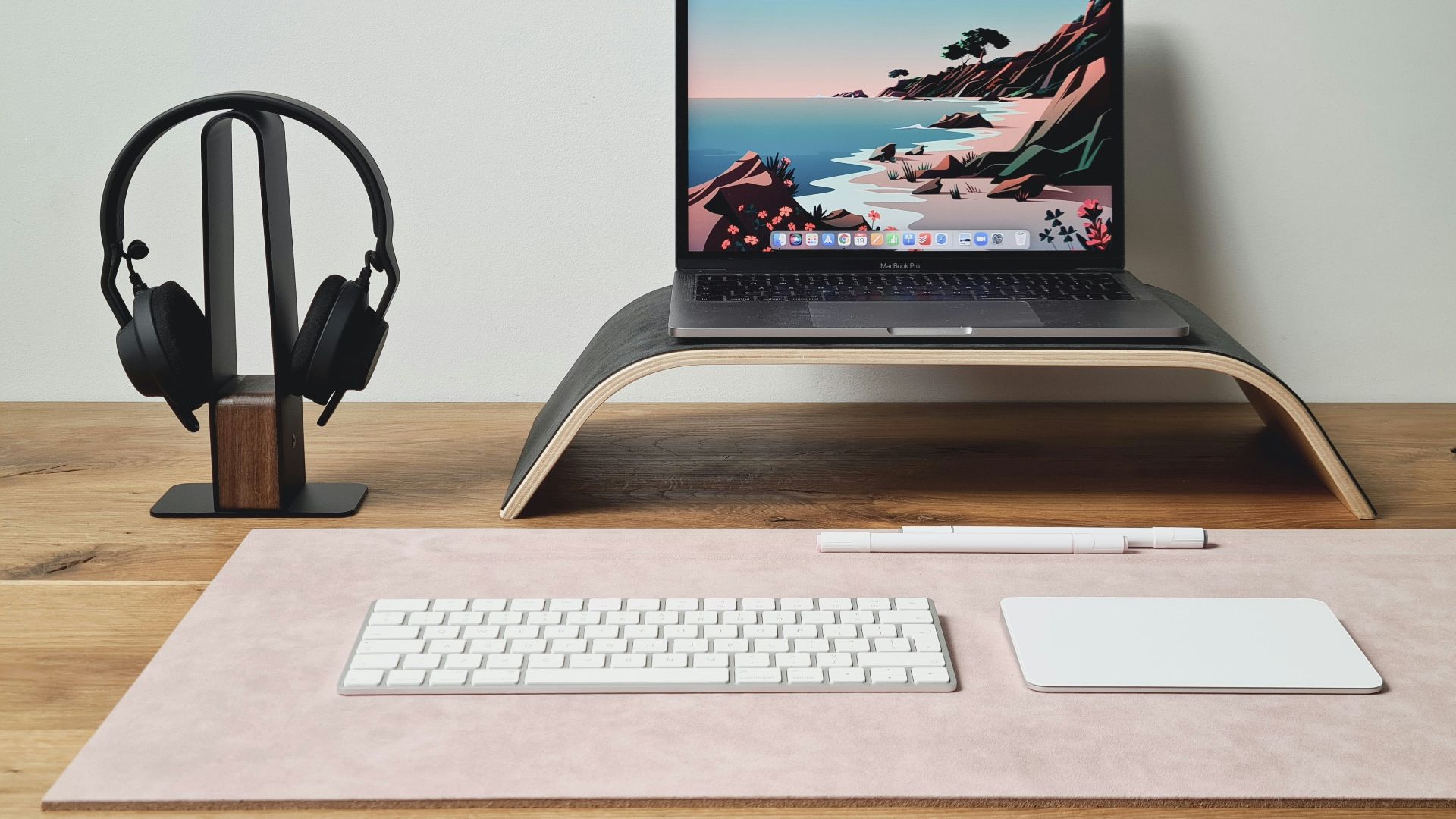 a laptop computer sitting on top of a wooden desk