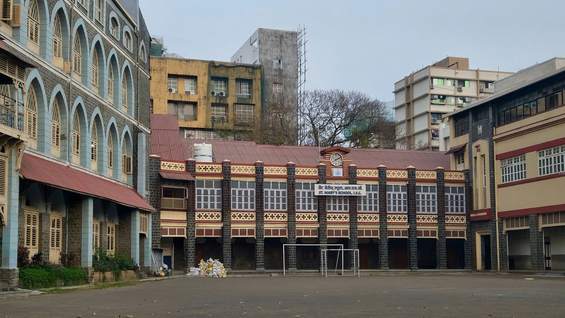 an empty parking lot with a building in the background