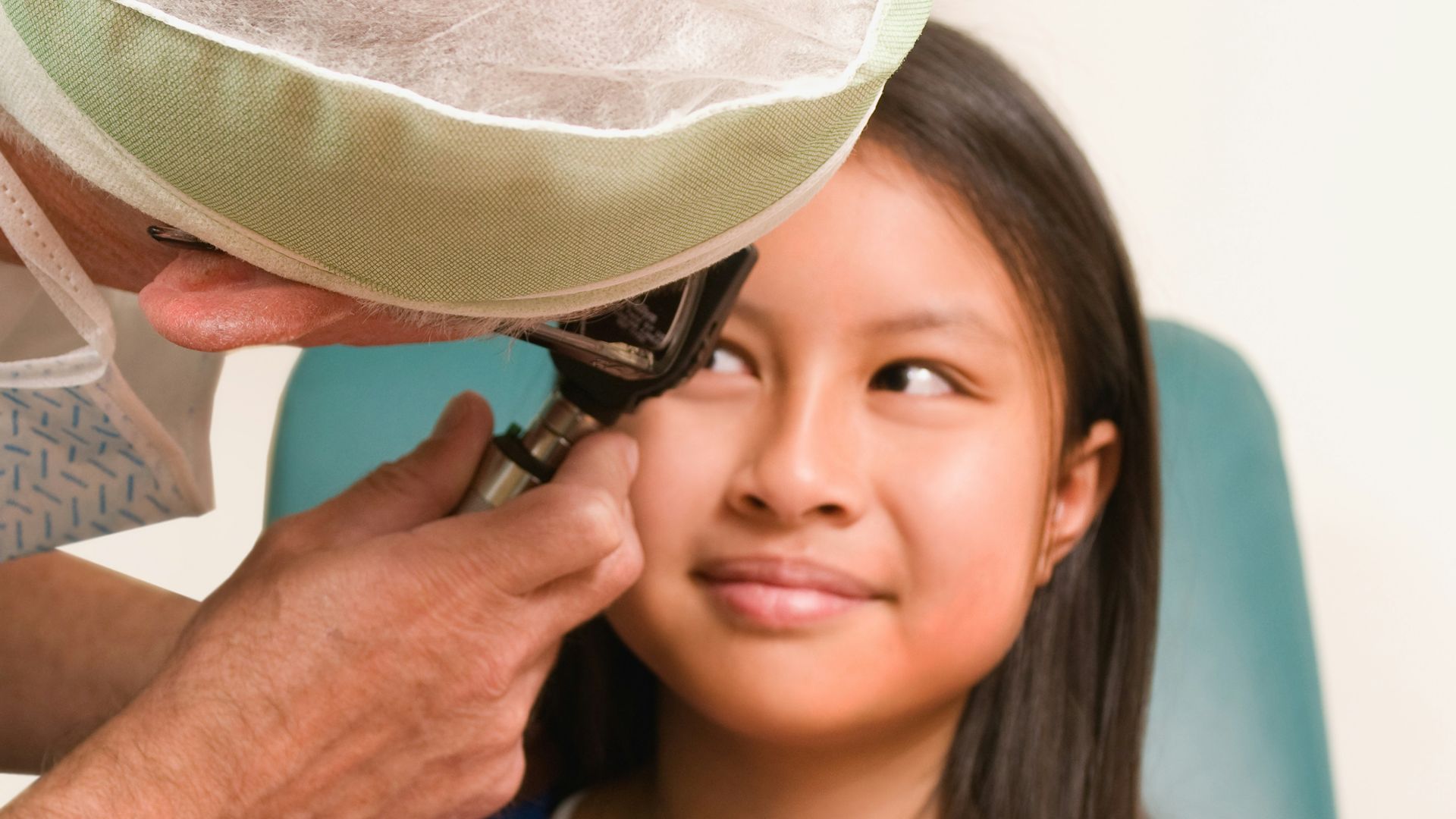 a little girl getting her hair combed by a man