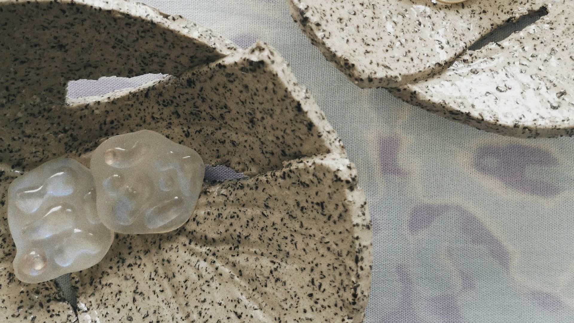 a couple of pieces of jewelry sitting on top of a table