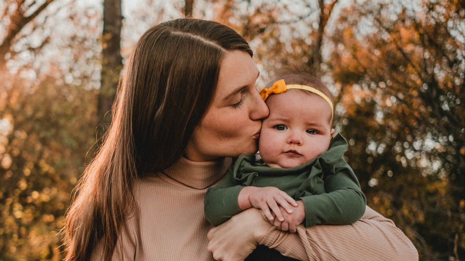 a woman holding a baby in her arms