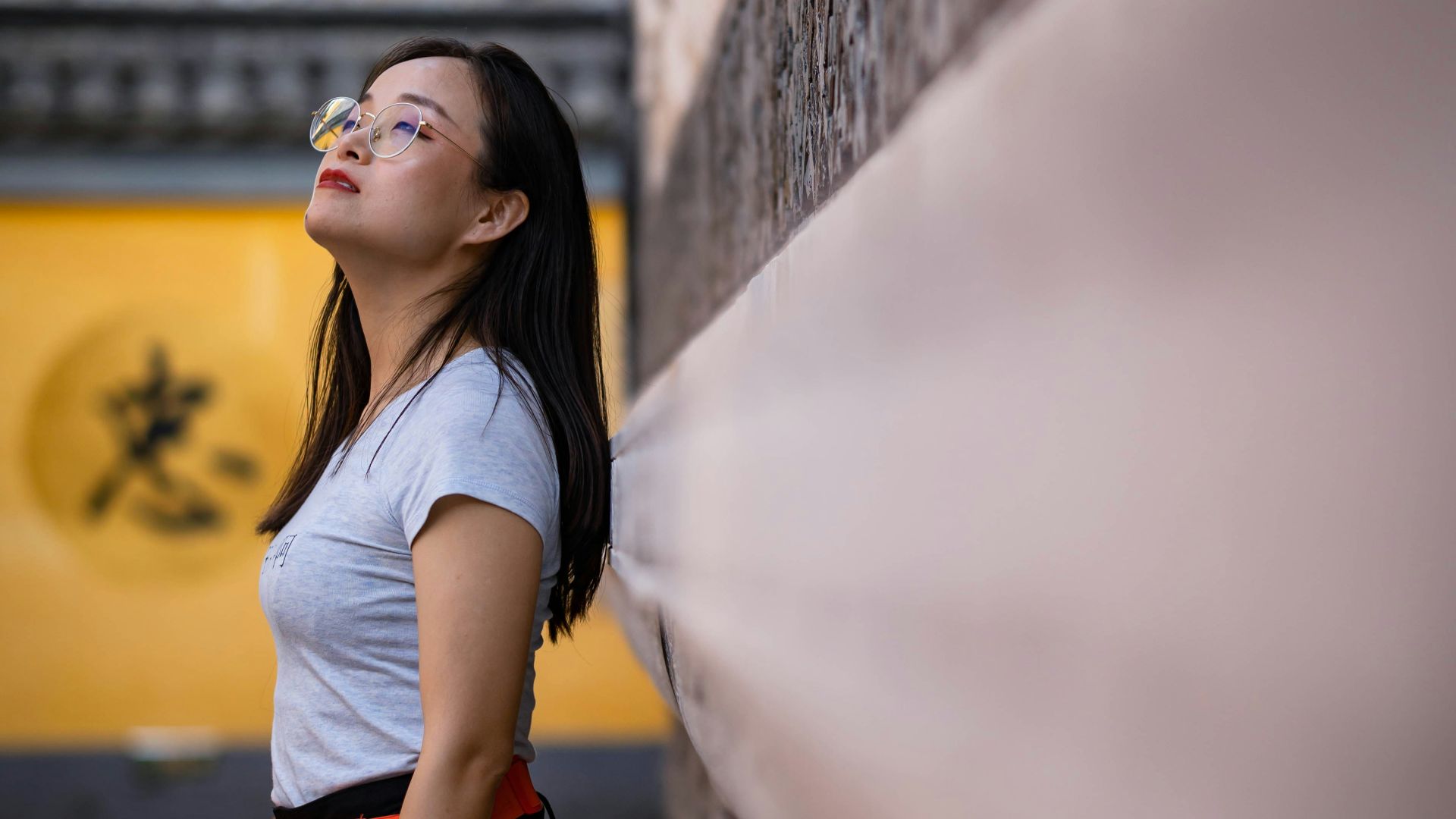 a woman standing in a narrow alley