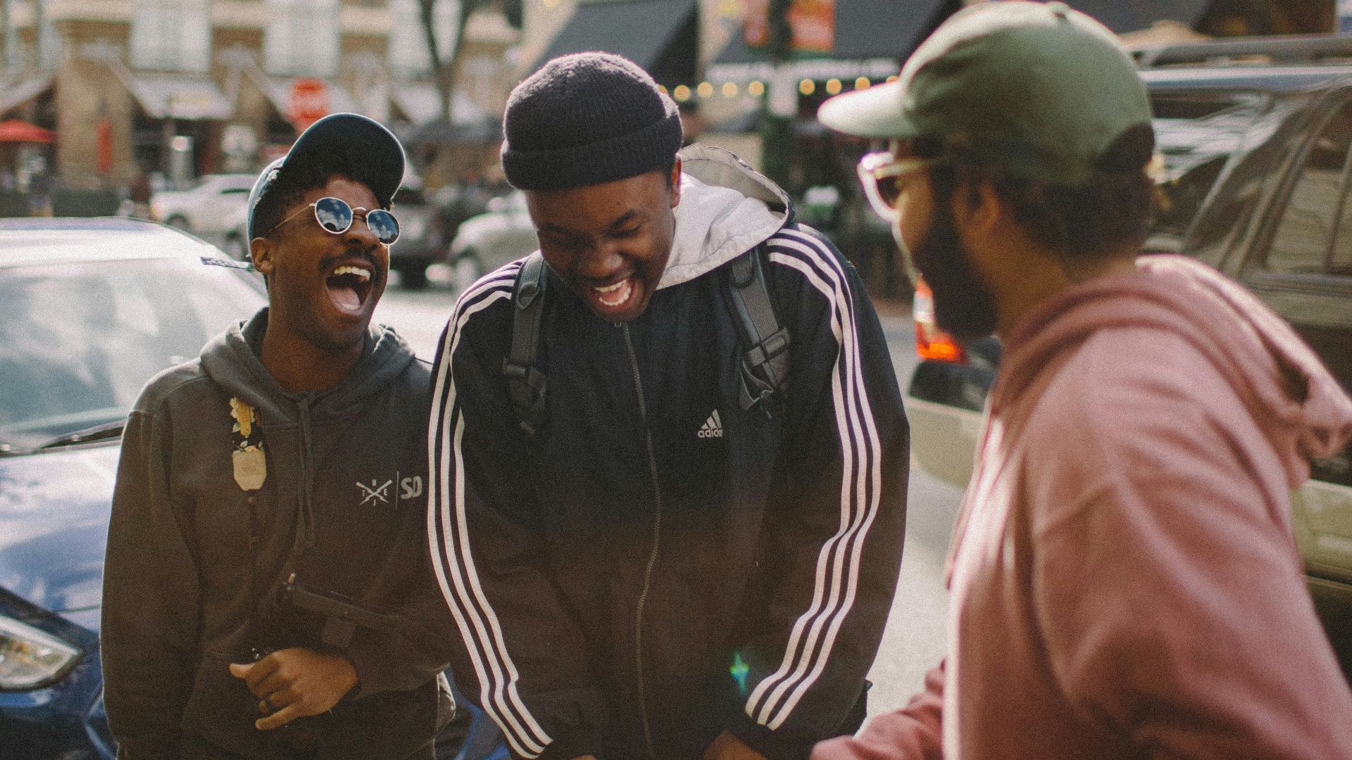 three men in jacket laughing at each other