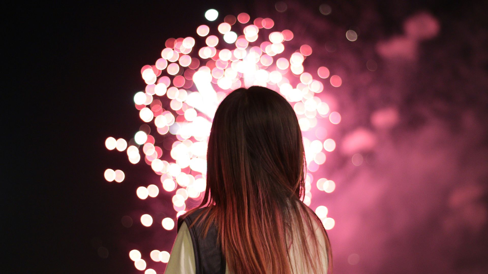 woman staring at fireworks