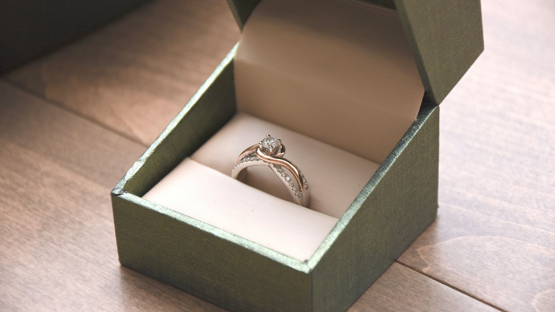 silver-colored ring with gemstone in a box