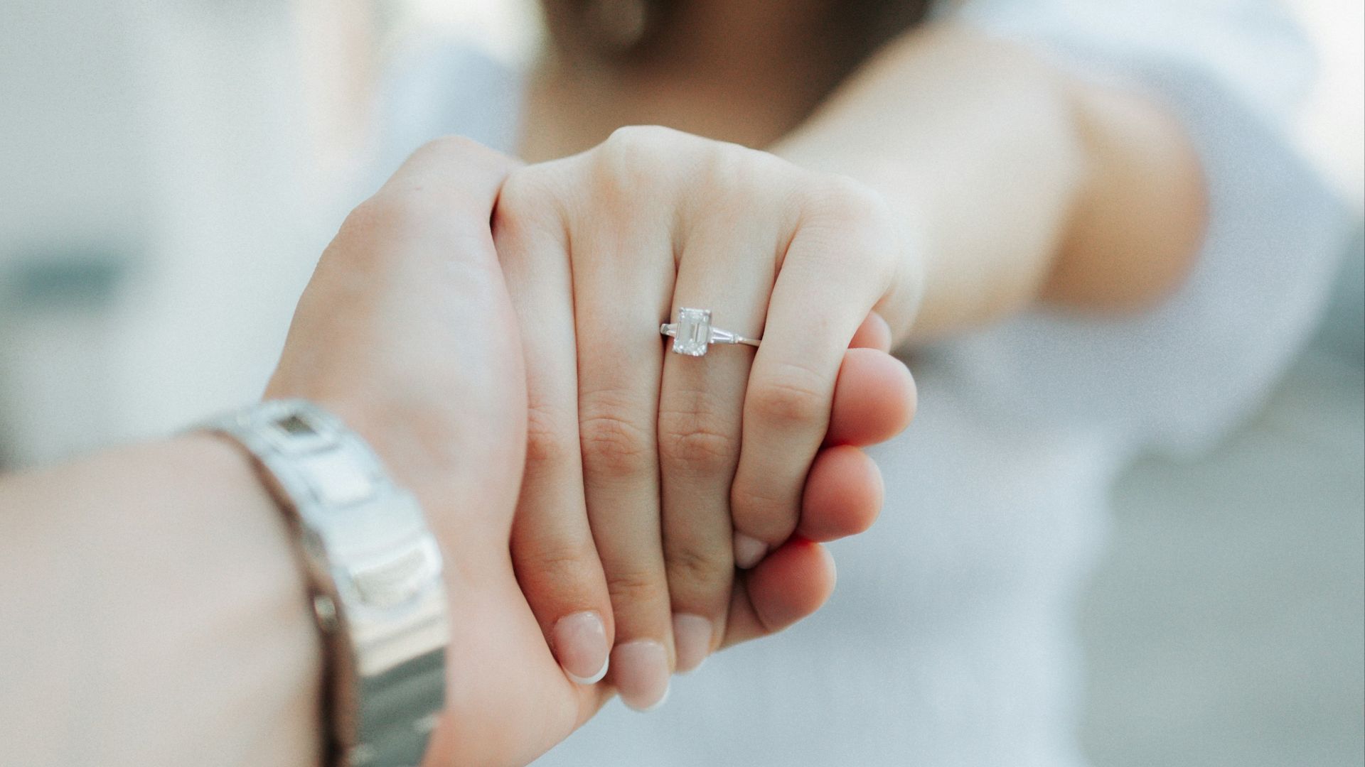 a close up of a person holding the hand of another person