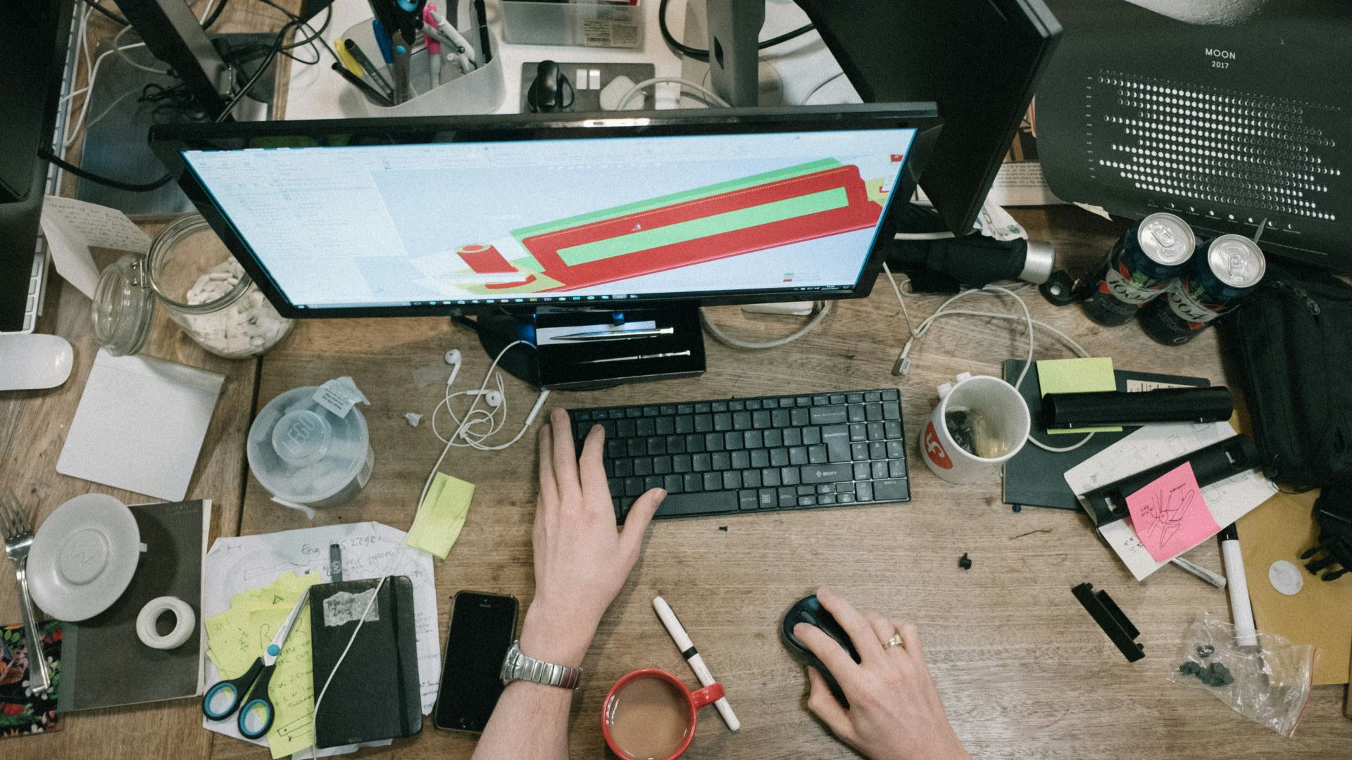 person using computer on brown wooden table