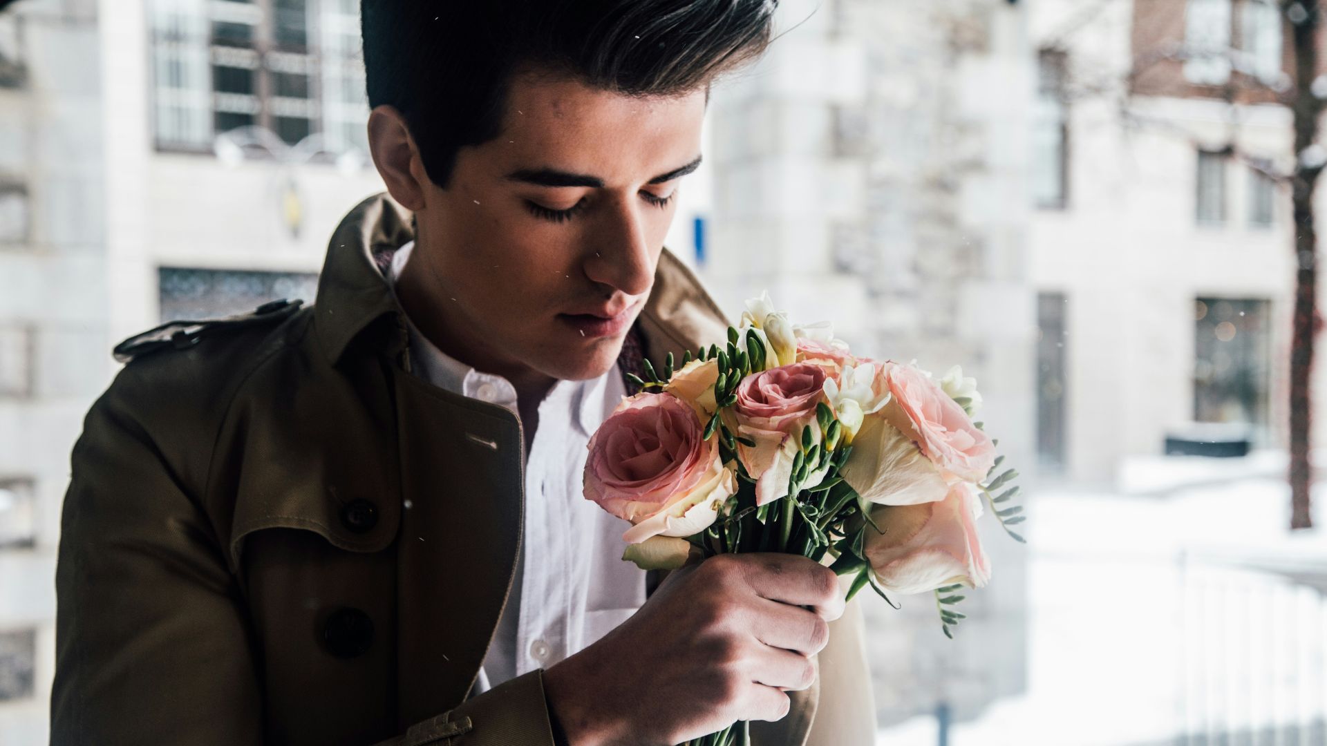 man holding pink roses