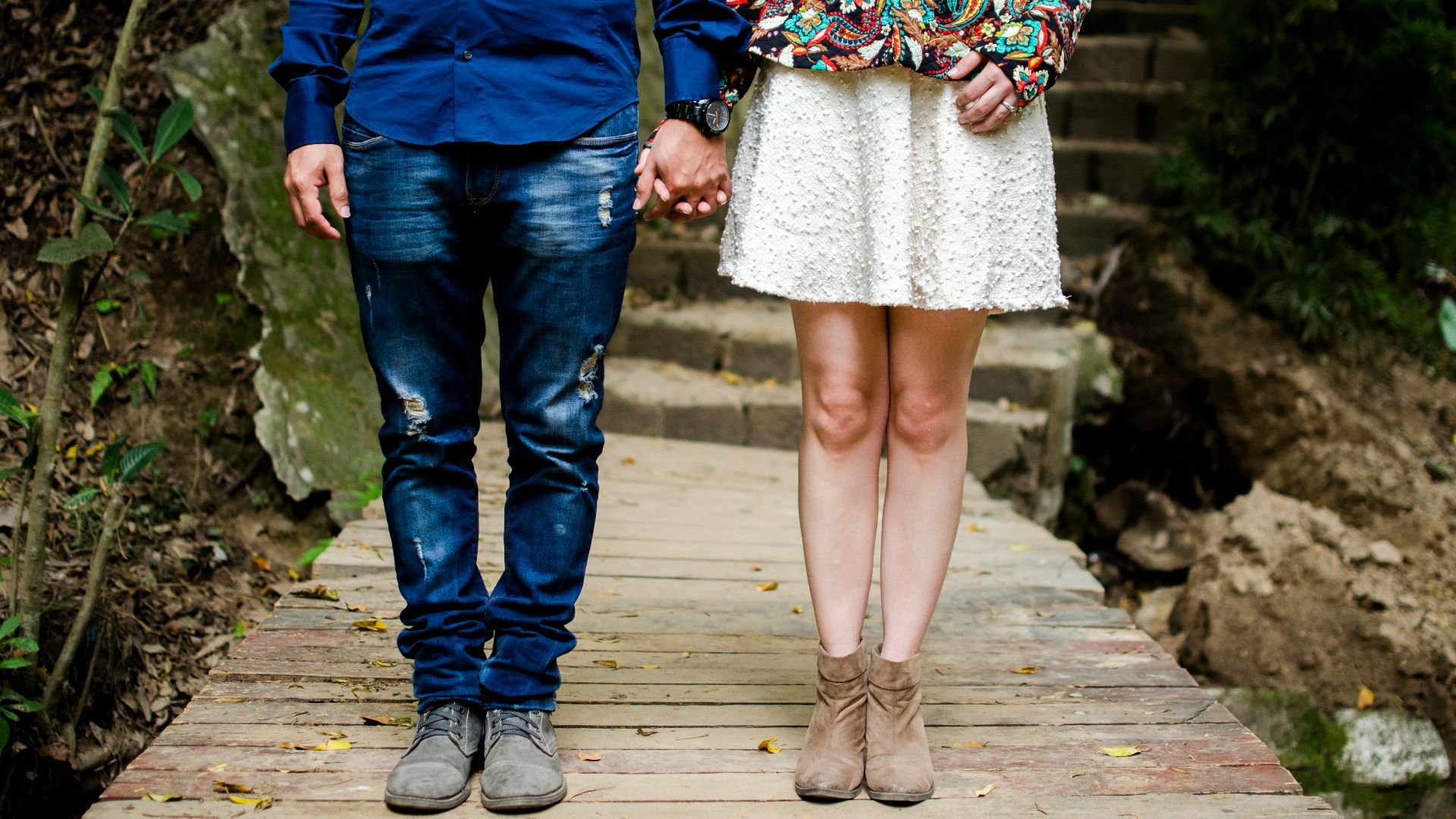 man and woman holding hands during daytime