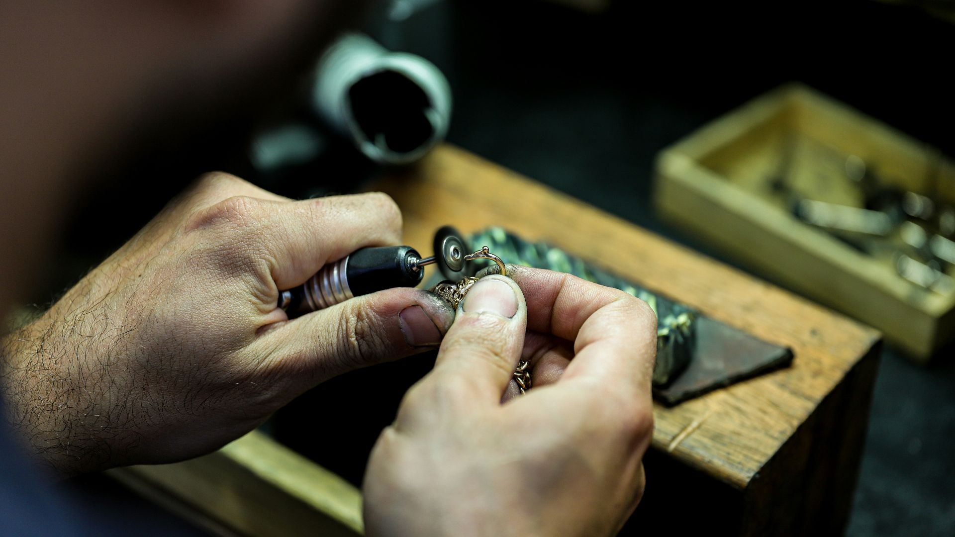 person wearing silver ring with black gemstone