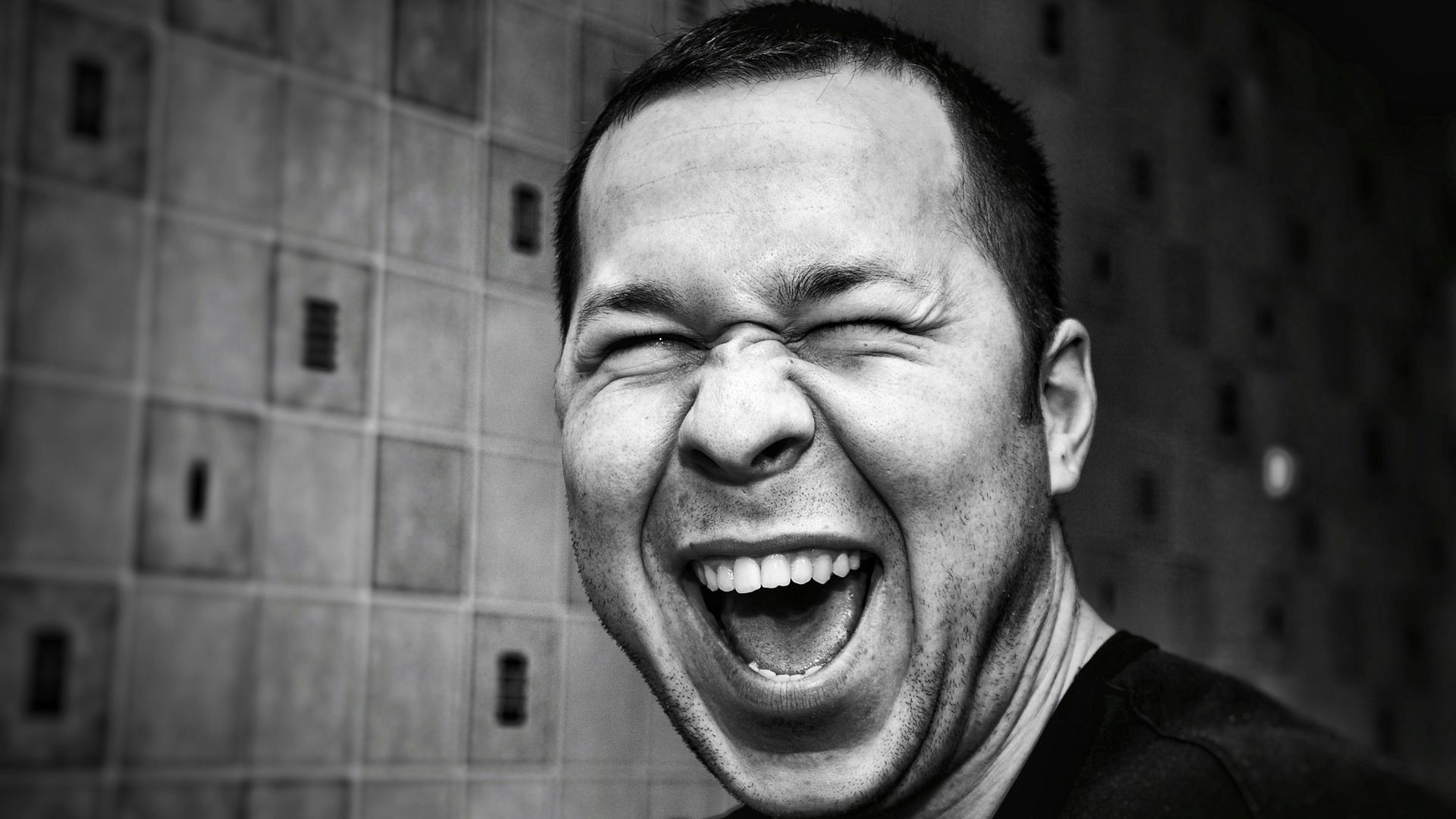 grayscale photo of man making silly face