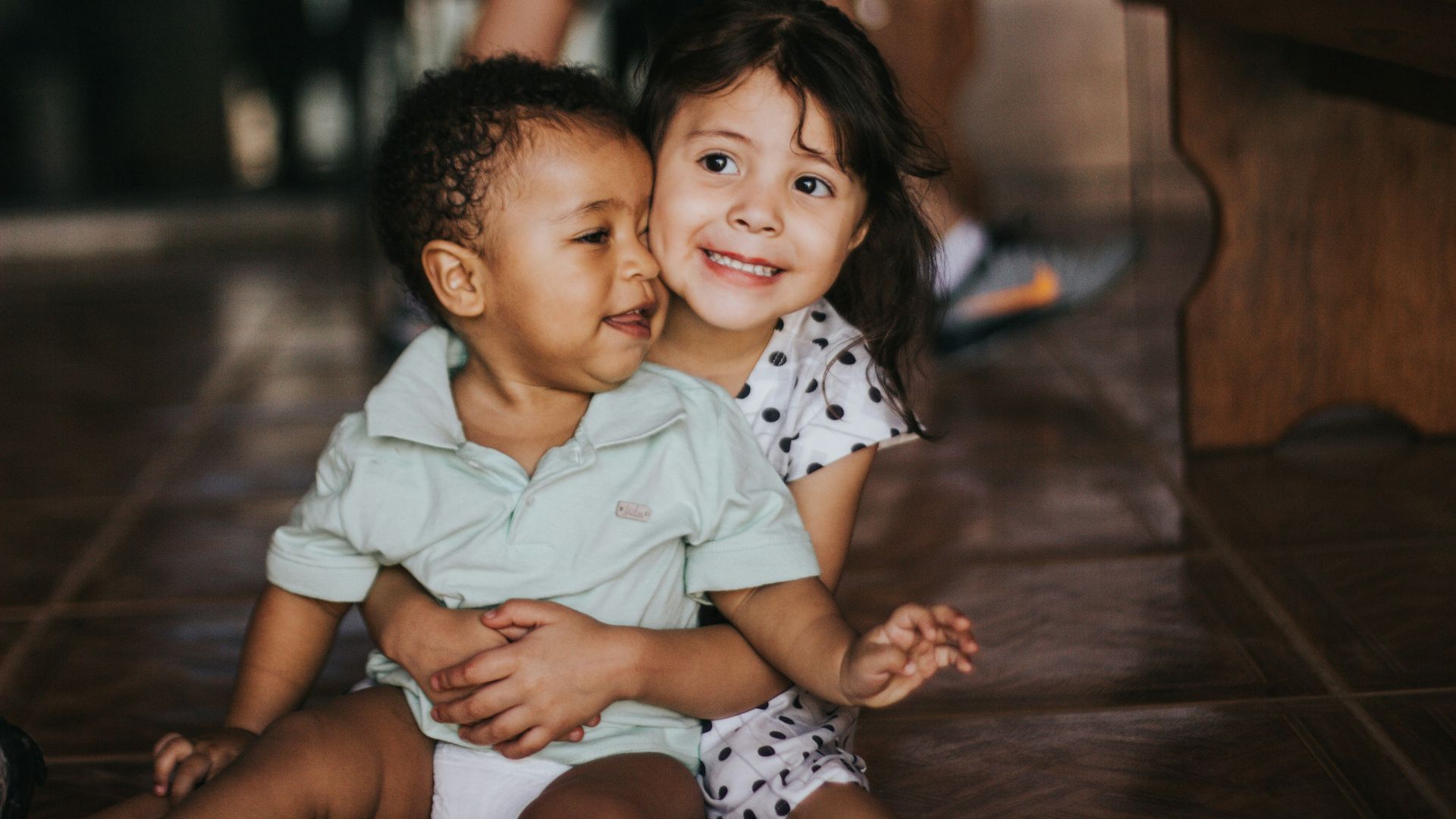 selective focus photography of girl hugging boy