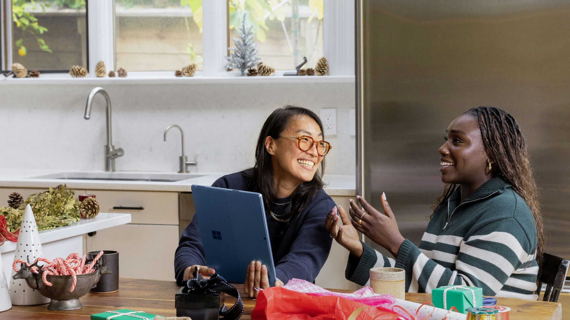 a woman sitting at a table in front of a window