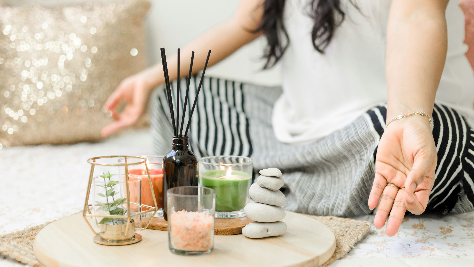 woman in white tank top holding black chopsticks