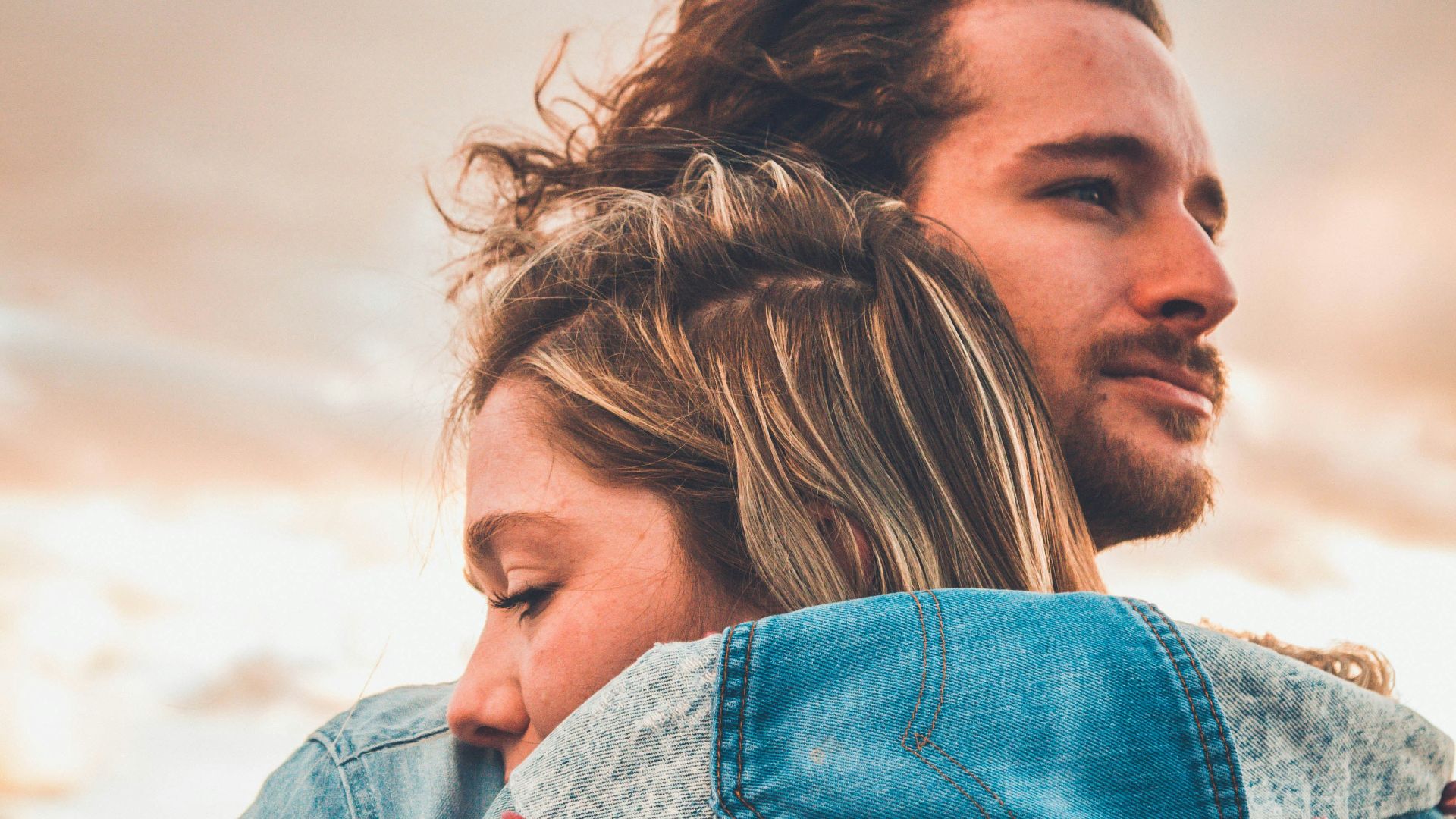 selective focus photography of couple hugging