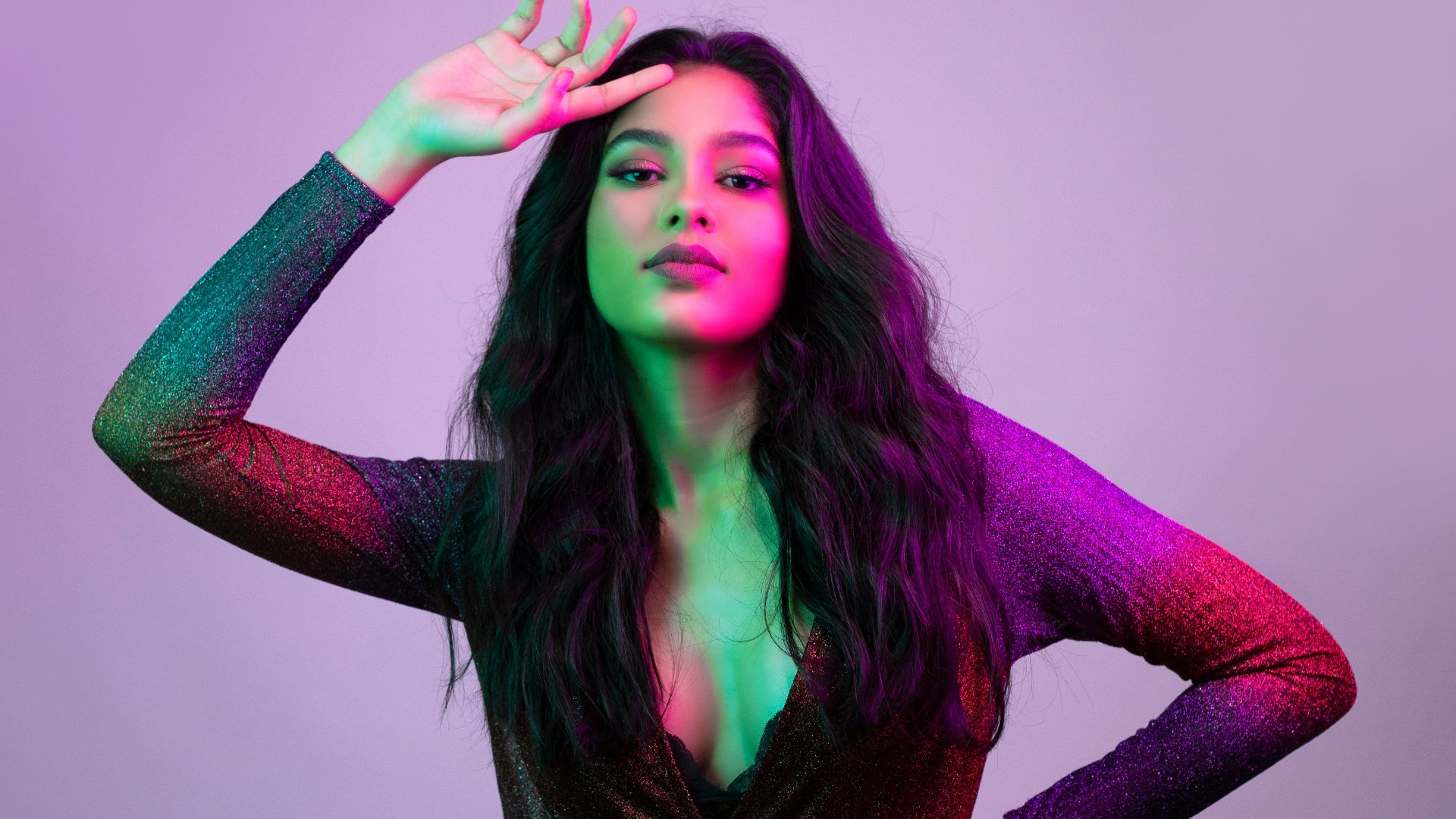 woman in purple long sleeve shirt and black skirt sitting on floor