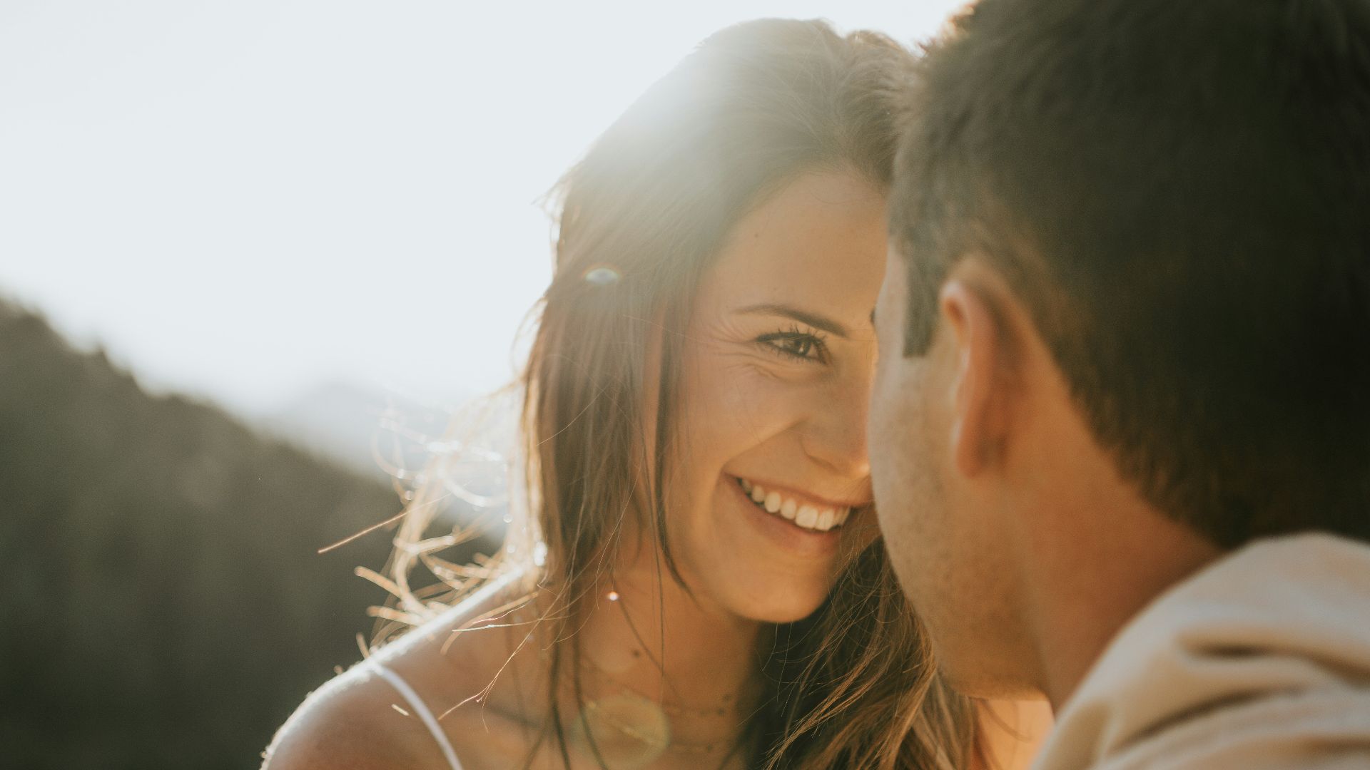 man and woman kissing during daytime