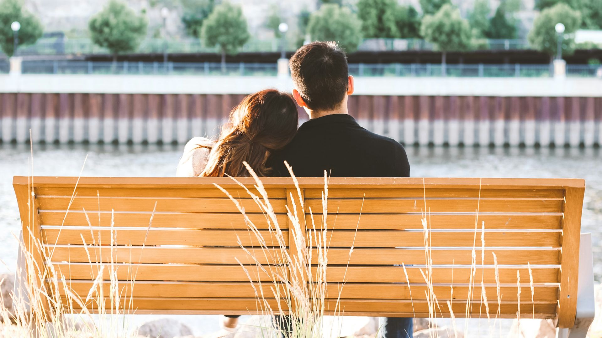 couple sitting on wooden bench