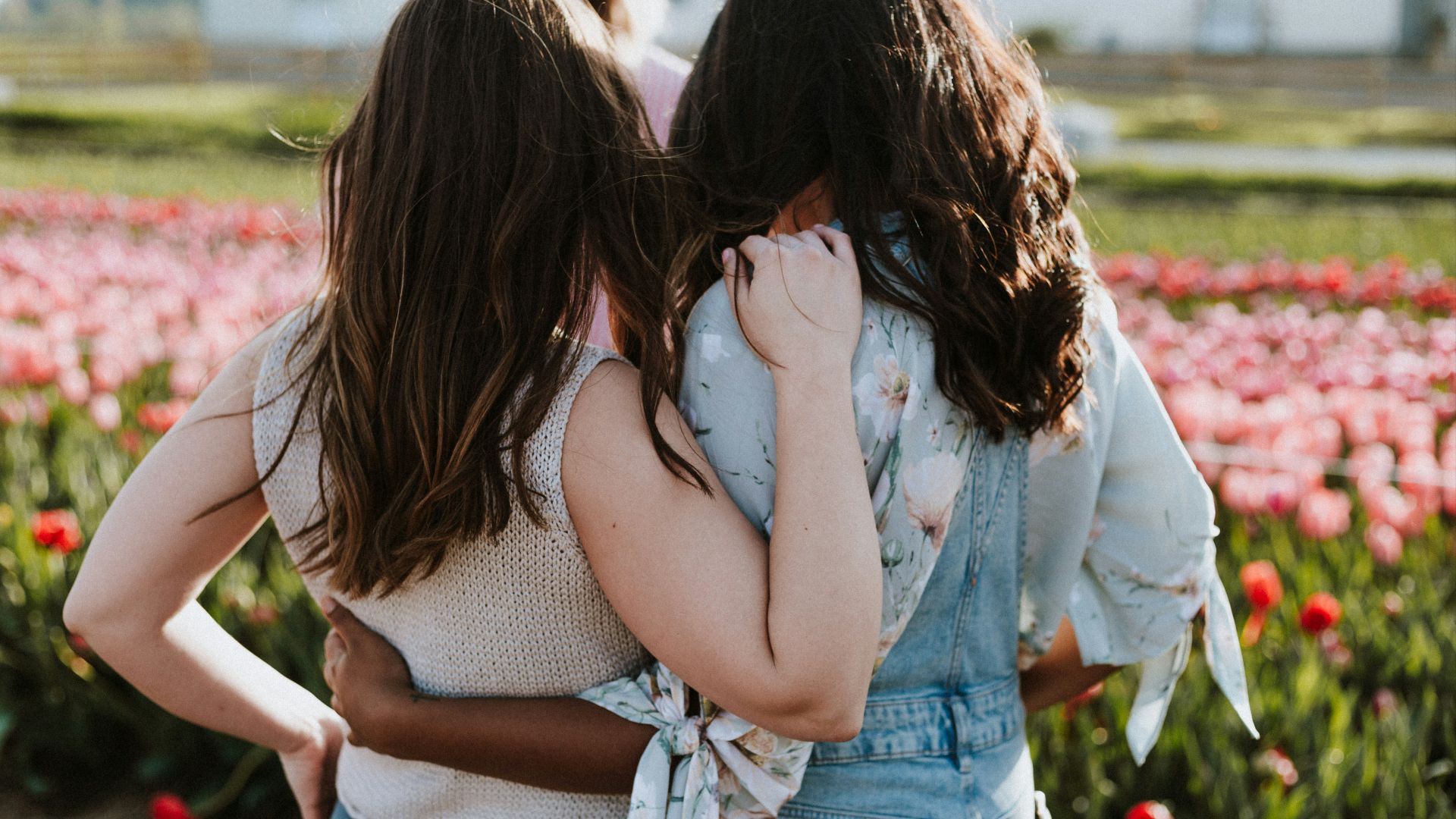 two women in front of flowers