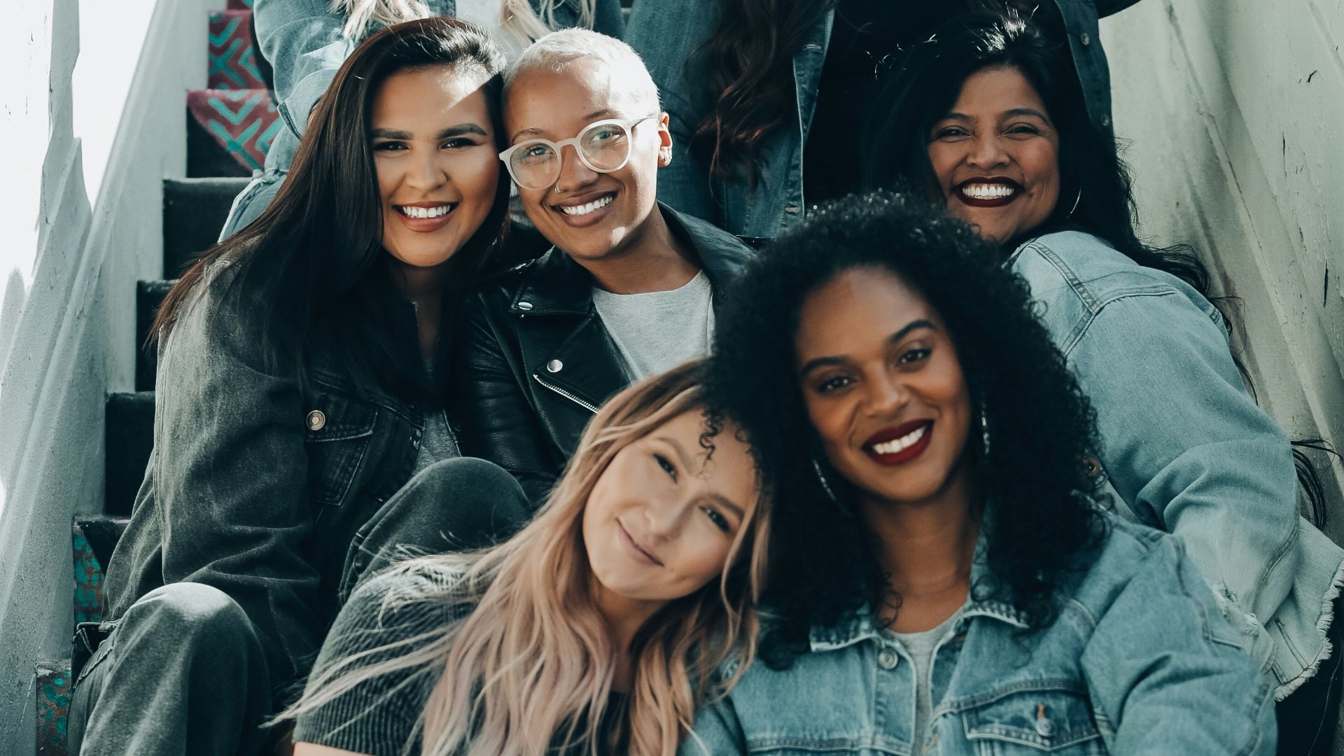 2 women sitting on black chair