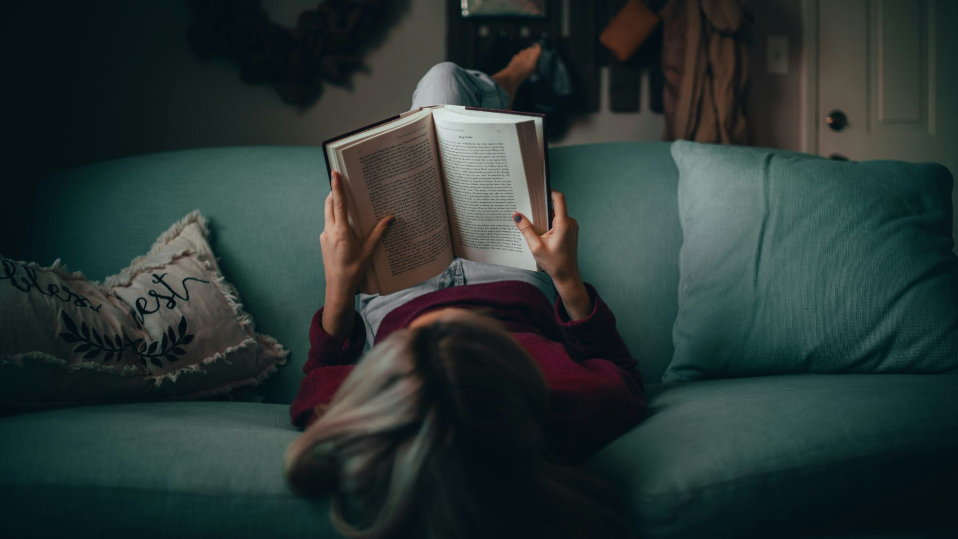 woman in red shirt reading book