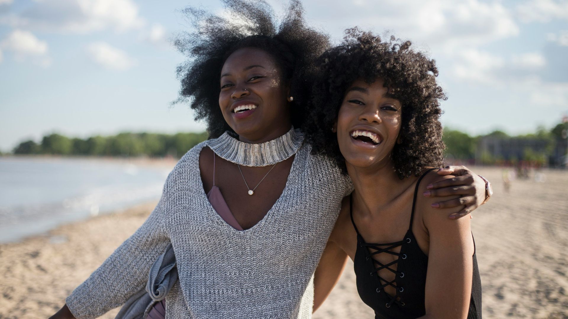 photo of woman beside another woman at seashore