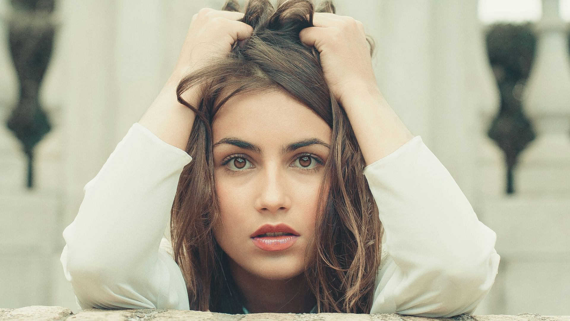 woman in white long sleeve shirt lying on bed