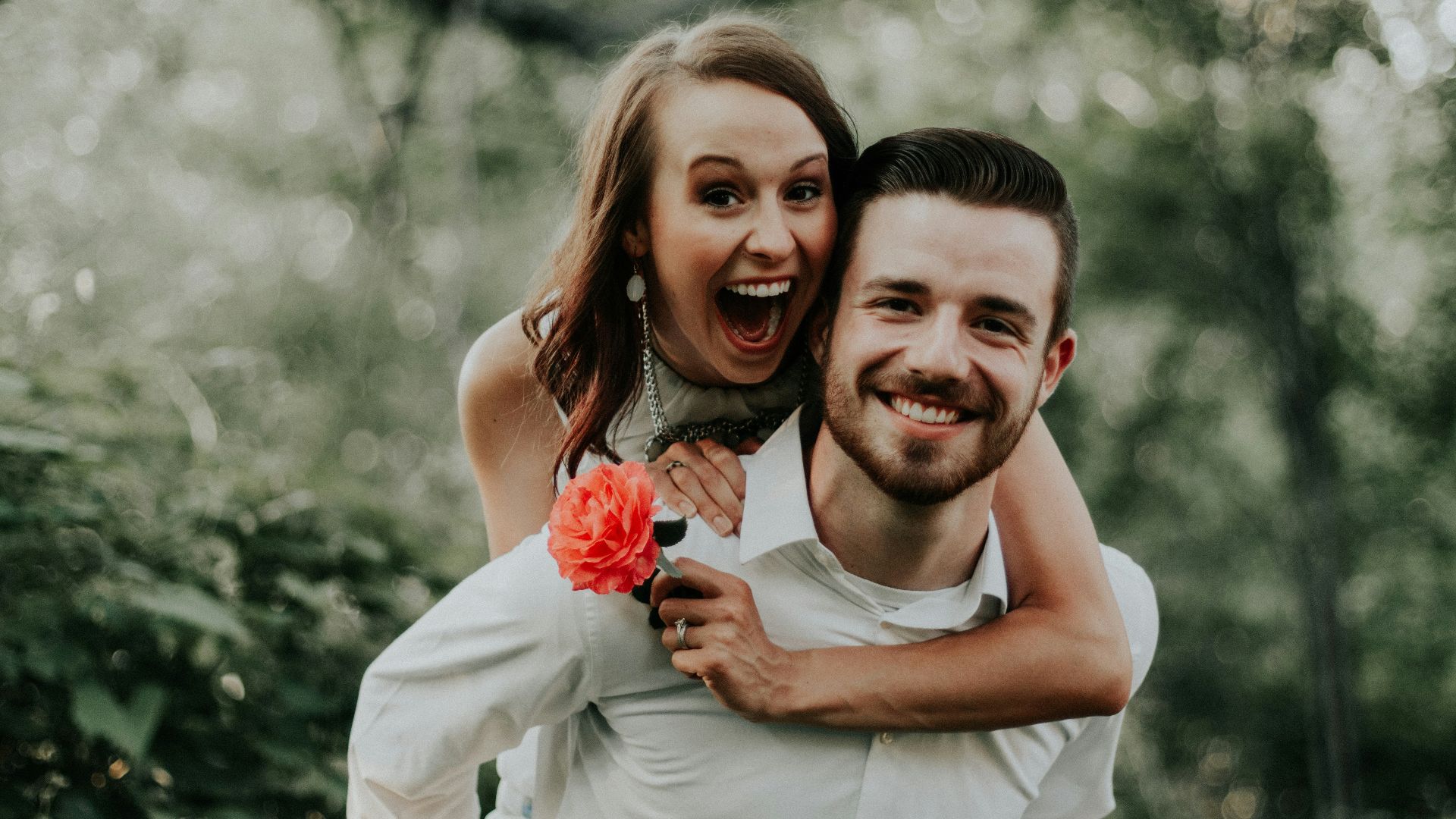 woman riding on back of man
