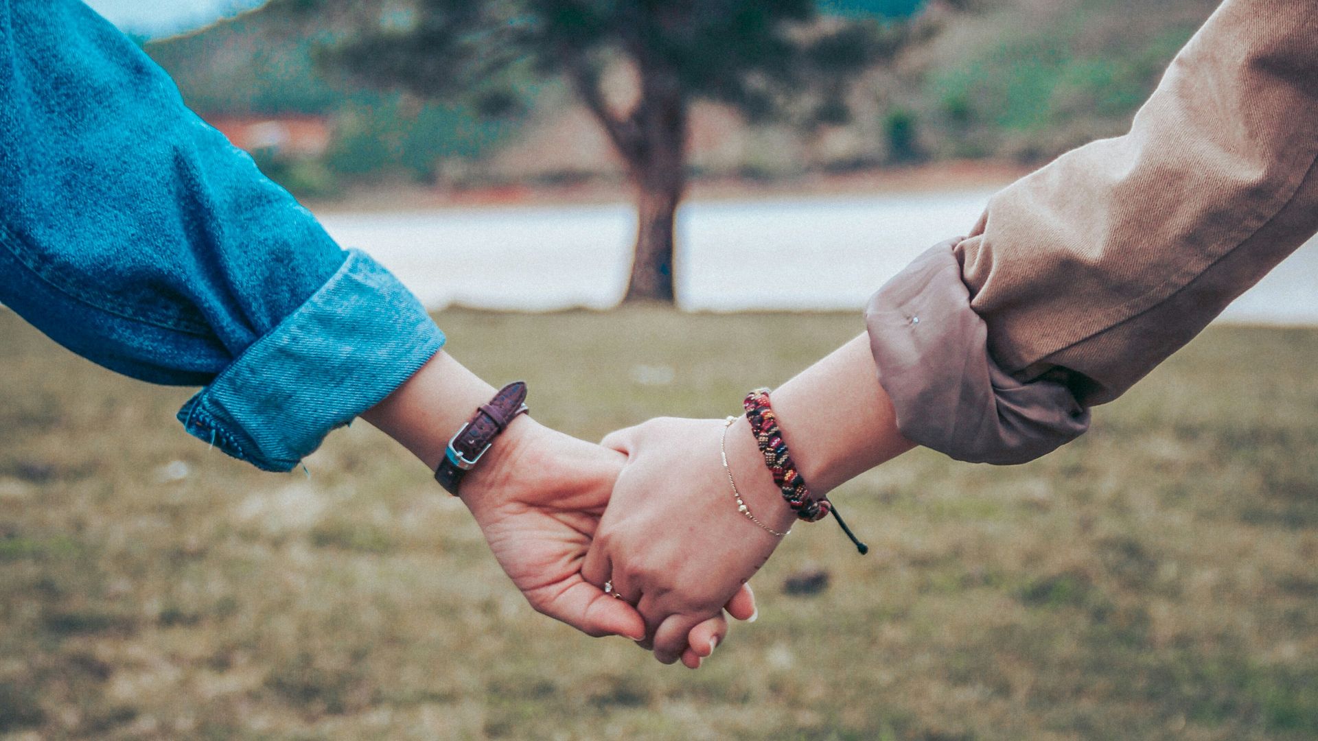 two persons holding hands