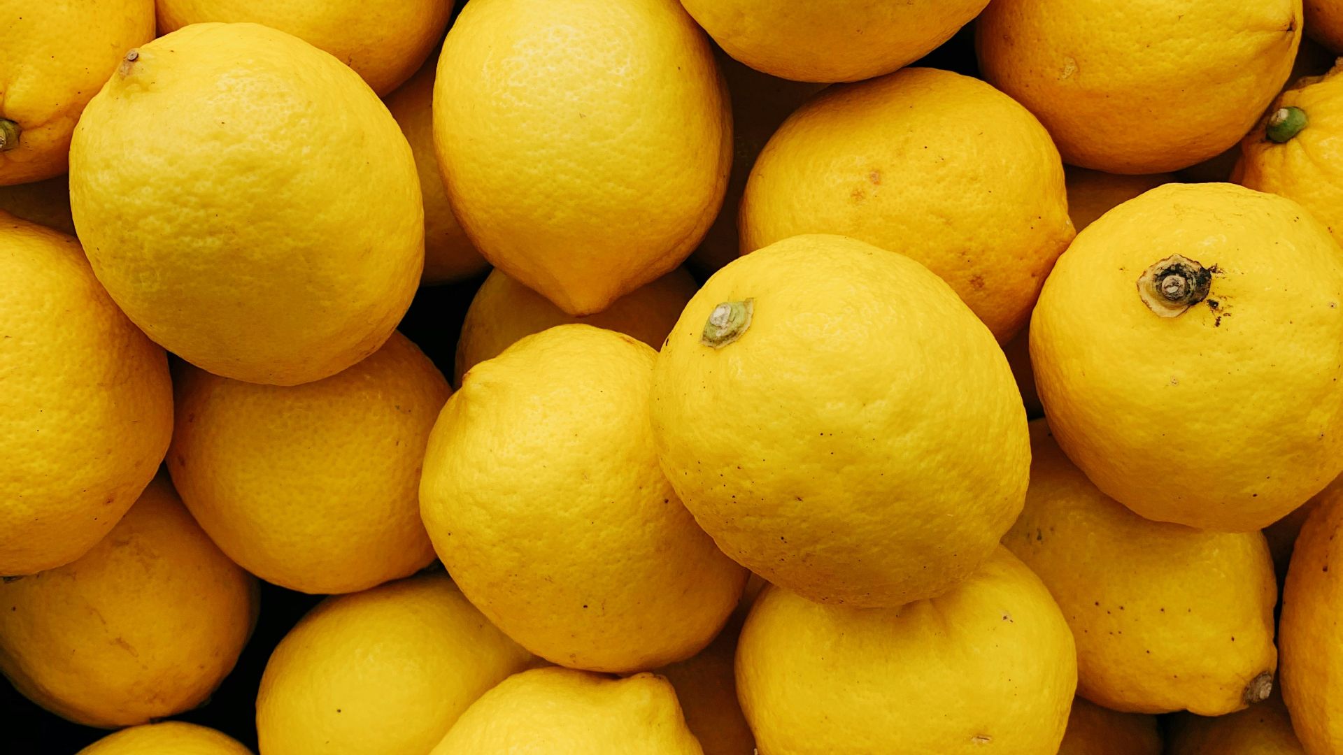 yellow citrus fruits on black surface