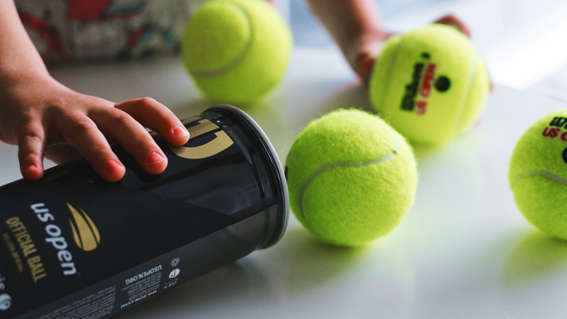 green tennis ball on white table